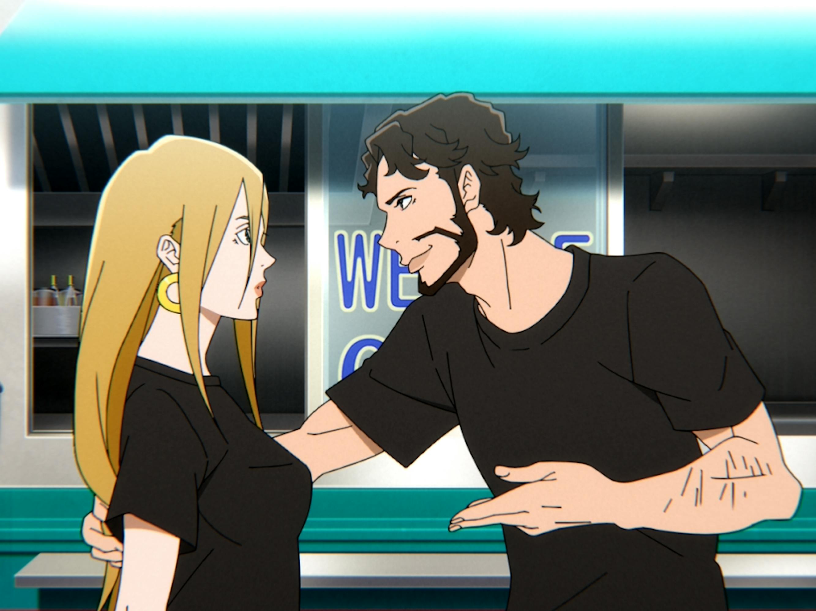 A blond woman and dark haired man wear black t-shirts and stand outside a storefront with a turquoise awning.