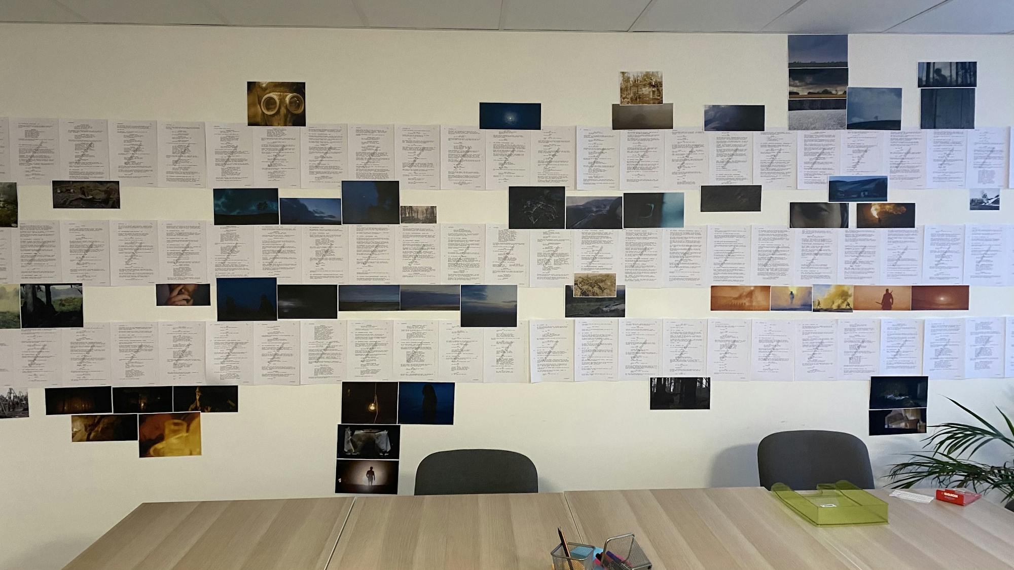 a moodboard taped to the wall with corresponding script sheets.