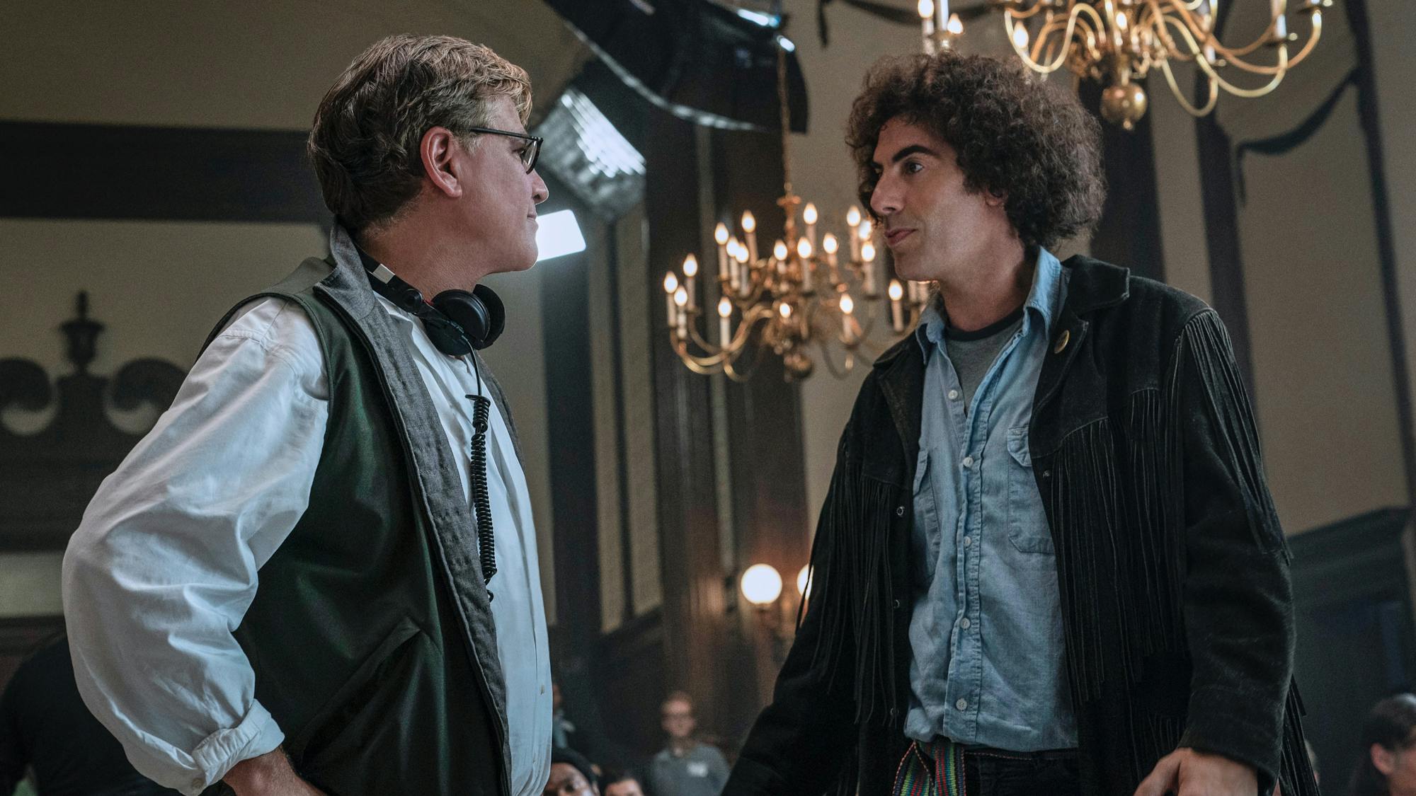 Aaron Sorkin directs Sacha Baron Cohen between takes for The Trial of the Chicago 7. 