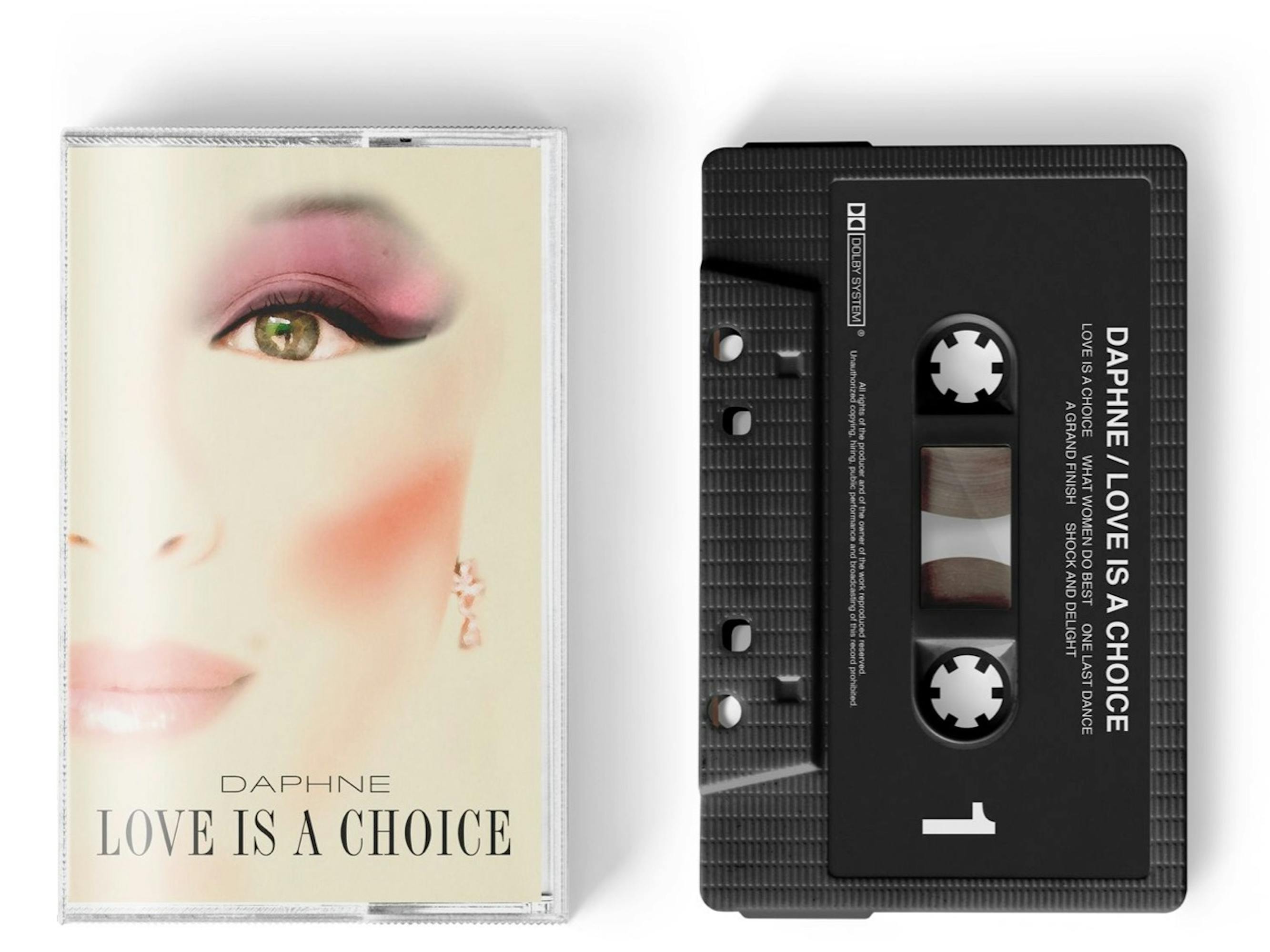 Daphne Bridgerton (Phoebe Dynevor) on a cassette tape cover. She wears pink eyeshadow, pink lipstick, and her cheekbone is accentuated with some blush. The cover and cassette itself read: “Daphne love is a choice.”
