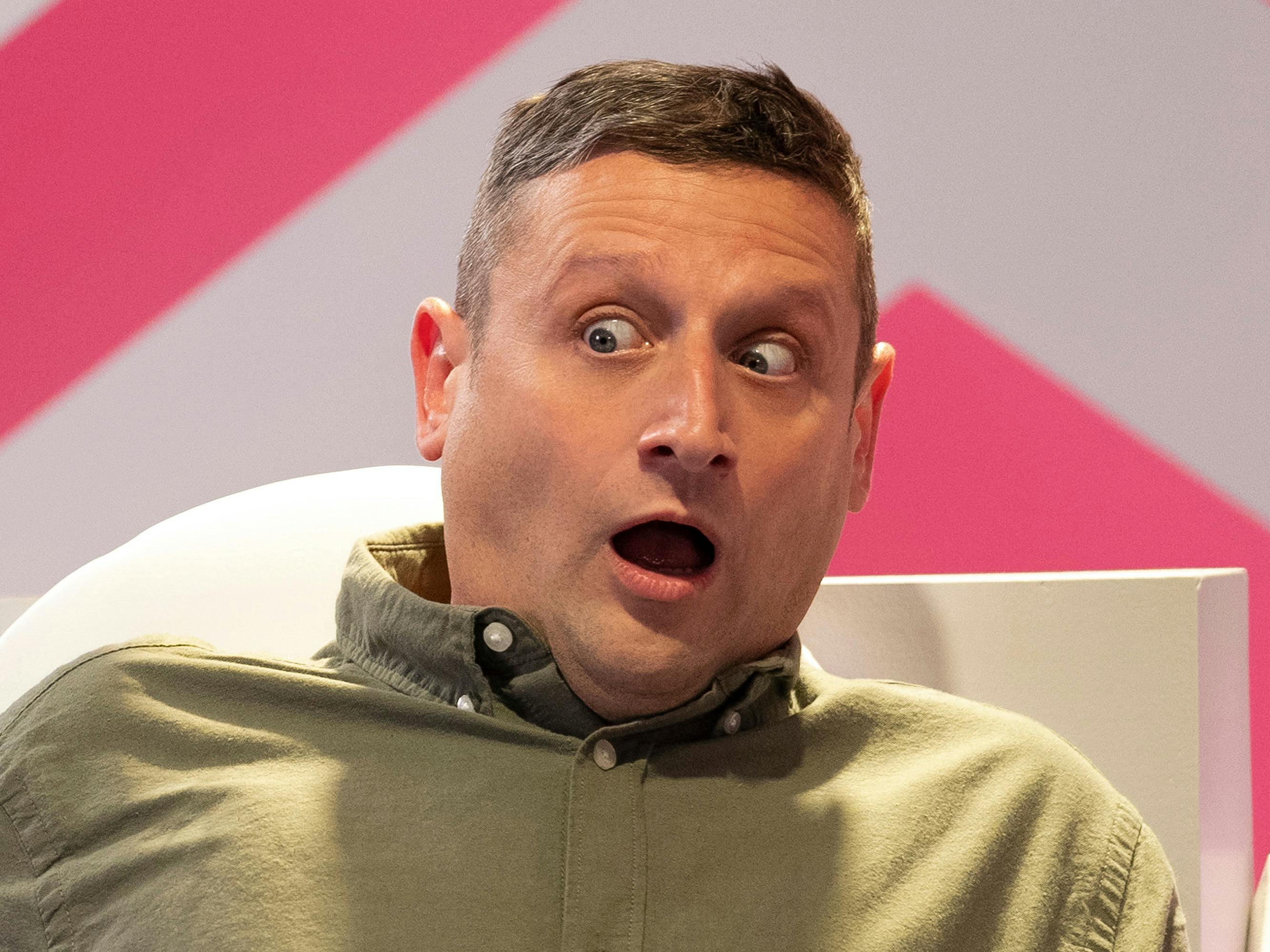 Tim Robinson wears a green shirt and looks shocked.