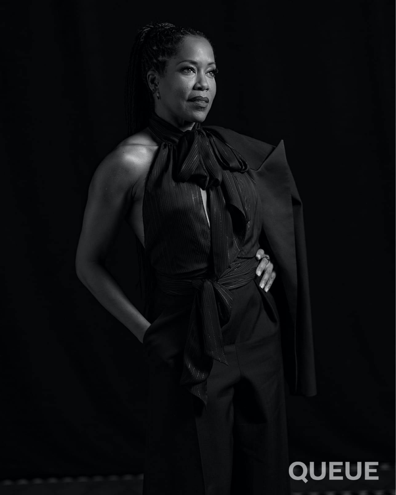 Regina King wears an all black ensemble in this chic black-and-white shot.