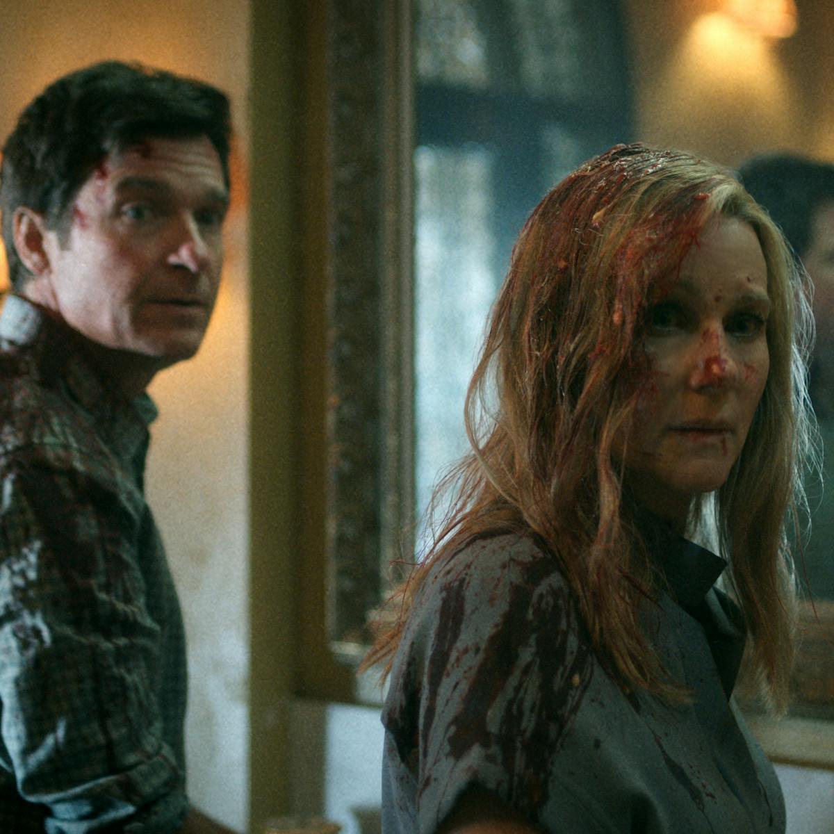 Jason Bateman and Laura Linney wear grey shirts and are covered in blood. Behind them is a big mirror.
