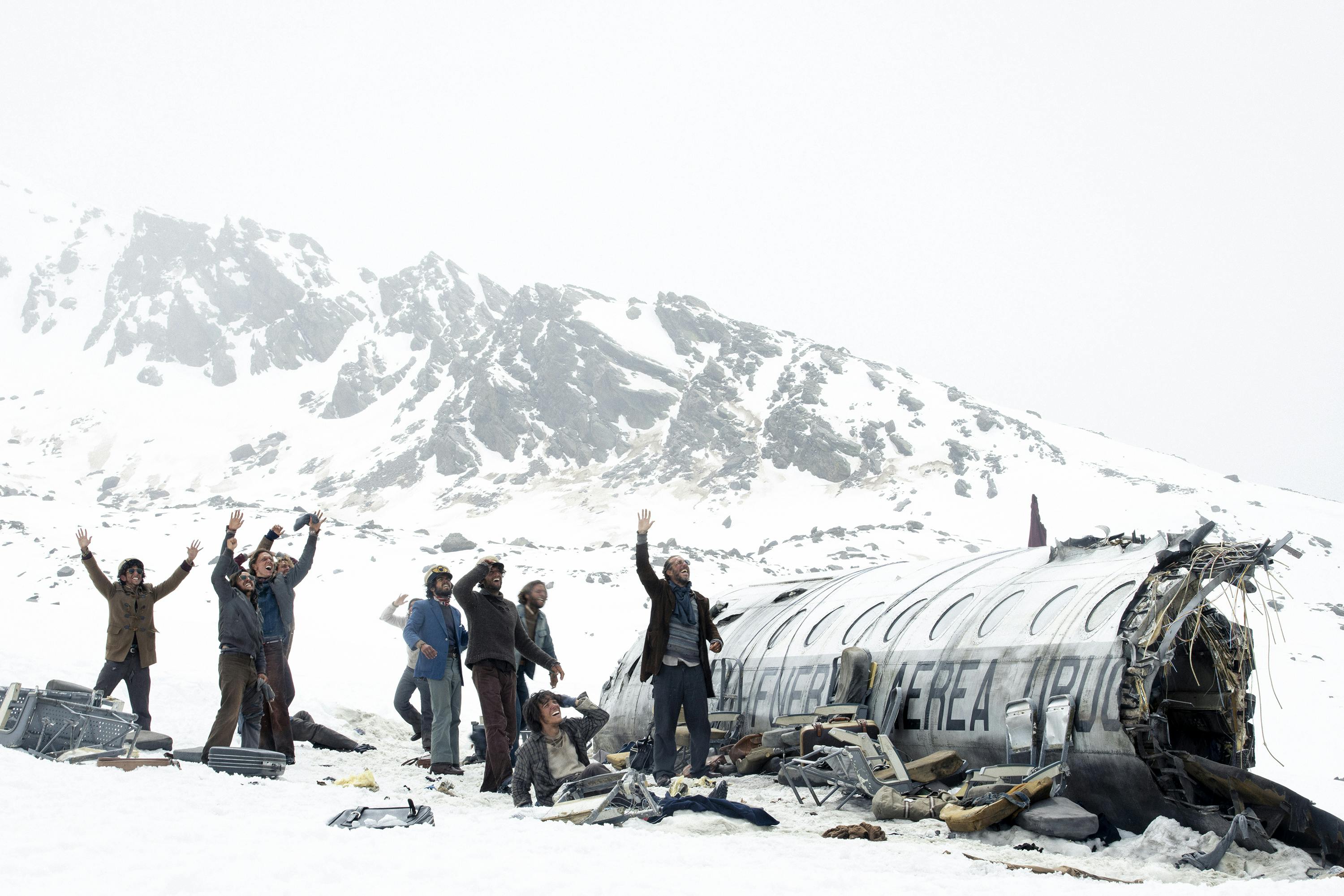 An image of people standing by a plane wreck in a snowy expanse.