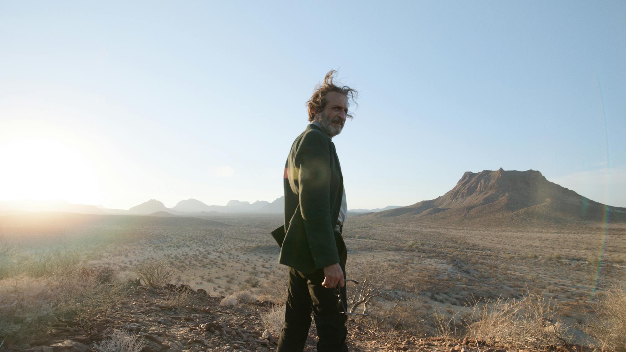 Silverio Gacho (Daniel Giménez Cacho) stands on a windswept plateau.