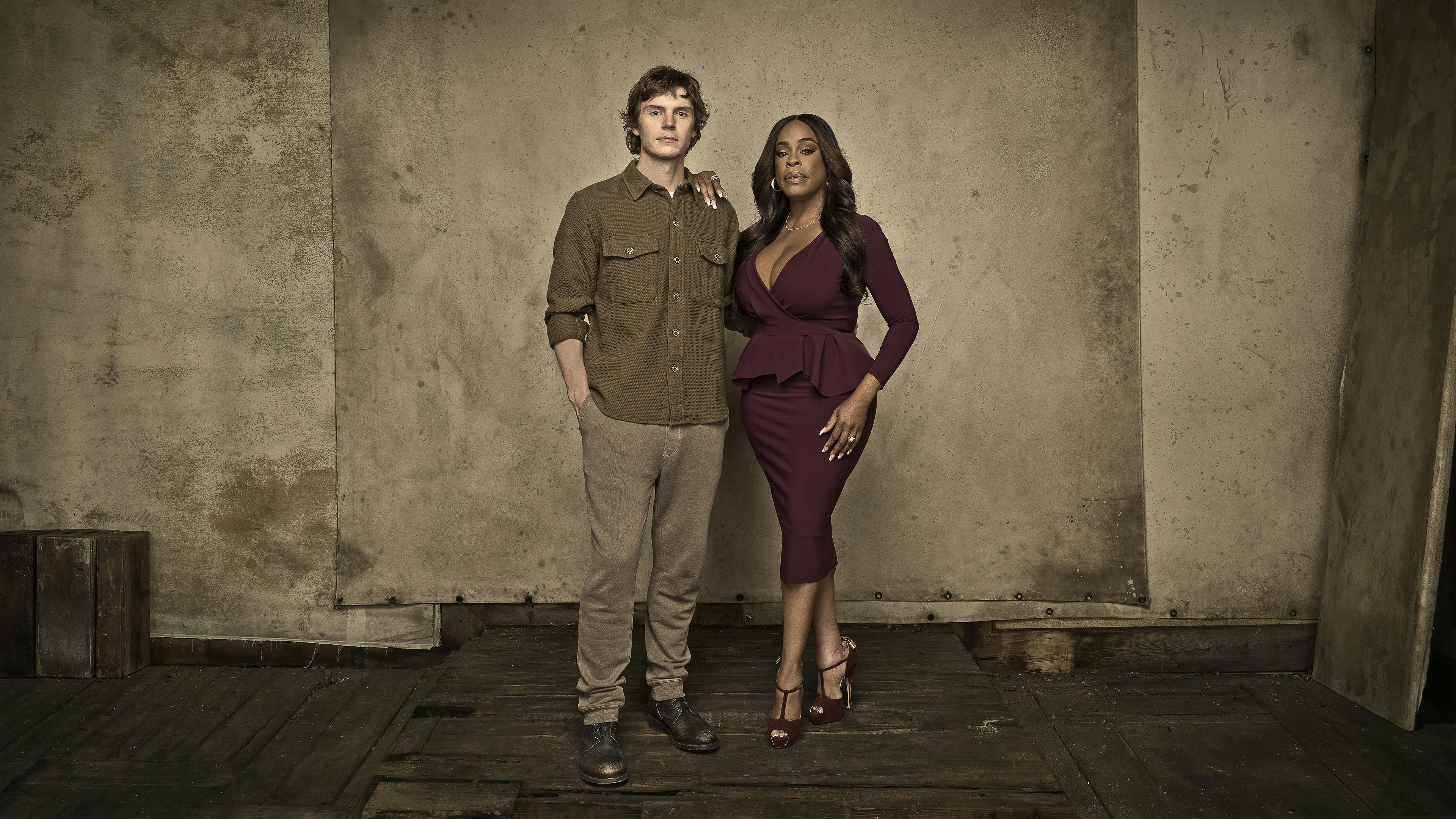 Evan Peters and Niecy Nash-Betts stand in a deserted looking area.