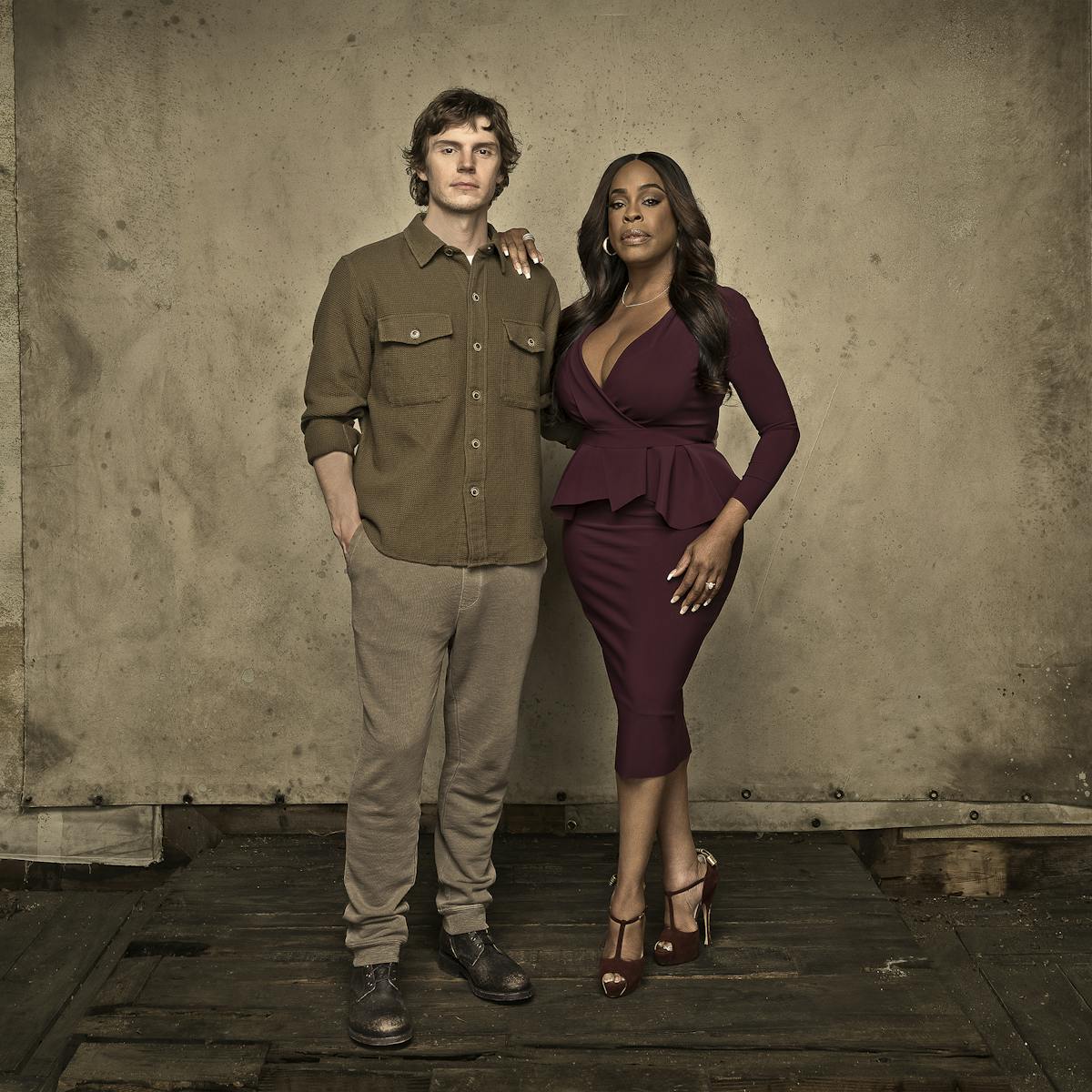 Evan Peters and Niecy Nash-Betts stand in a deserted looking area.