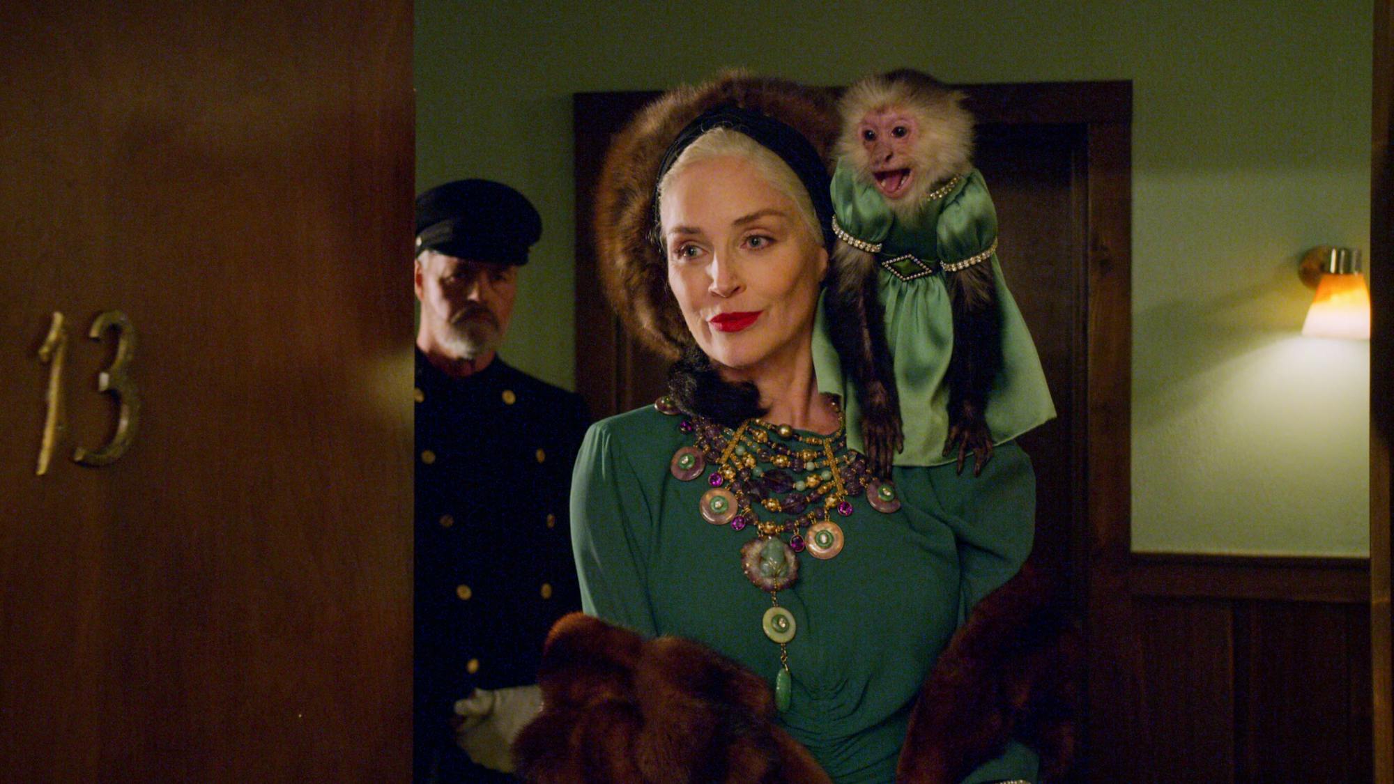 Lenore Osgood is pictured in a green dress and furs, all perfectly coordinated to match the monkey perched on her shoulder. 