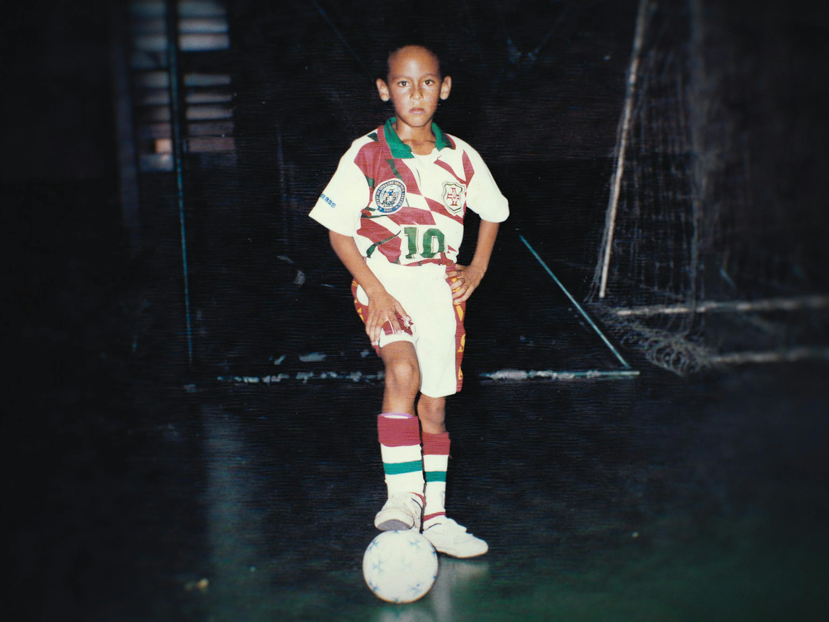 Baby Neymar wears a white soccer outfit with green and red trimming.
