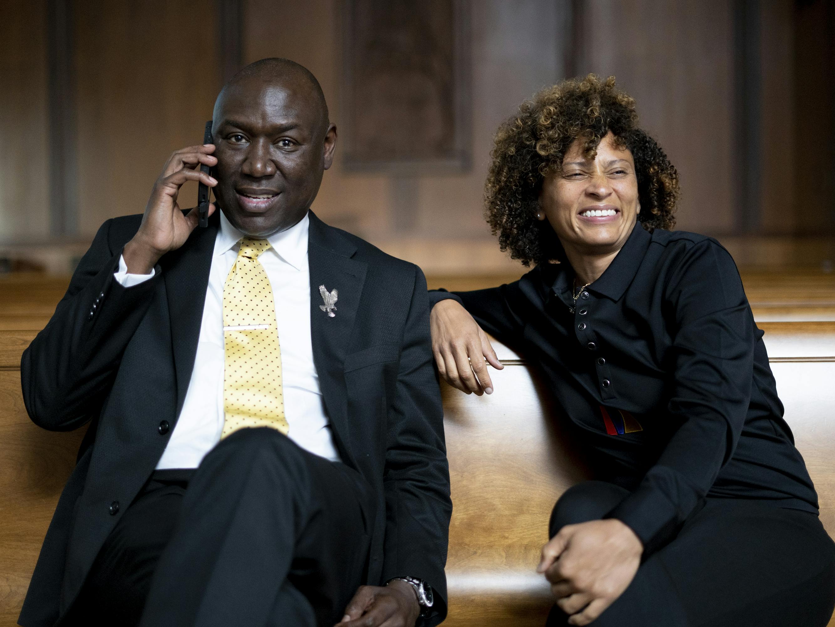 Ben Crump and Nadia Hallgren sit together in pew.