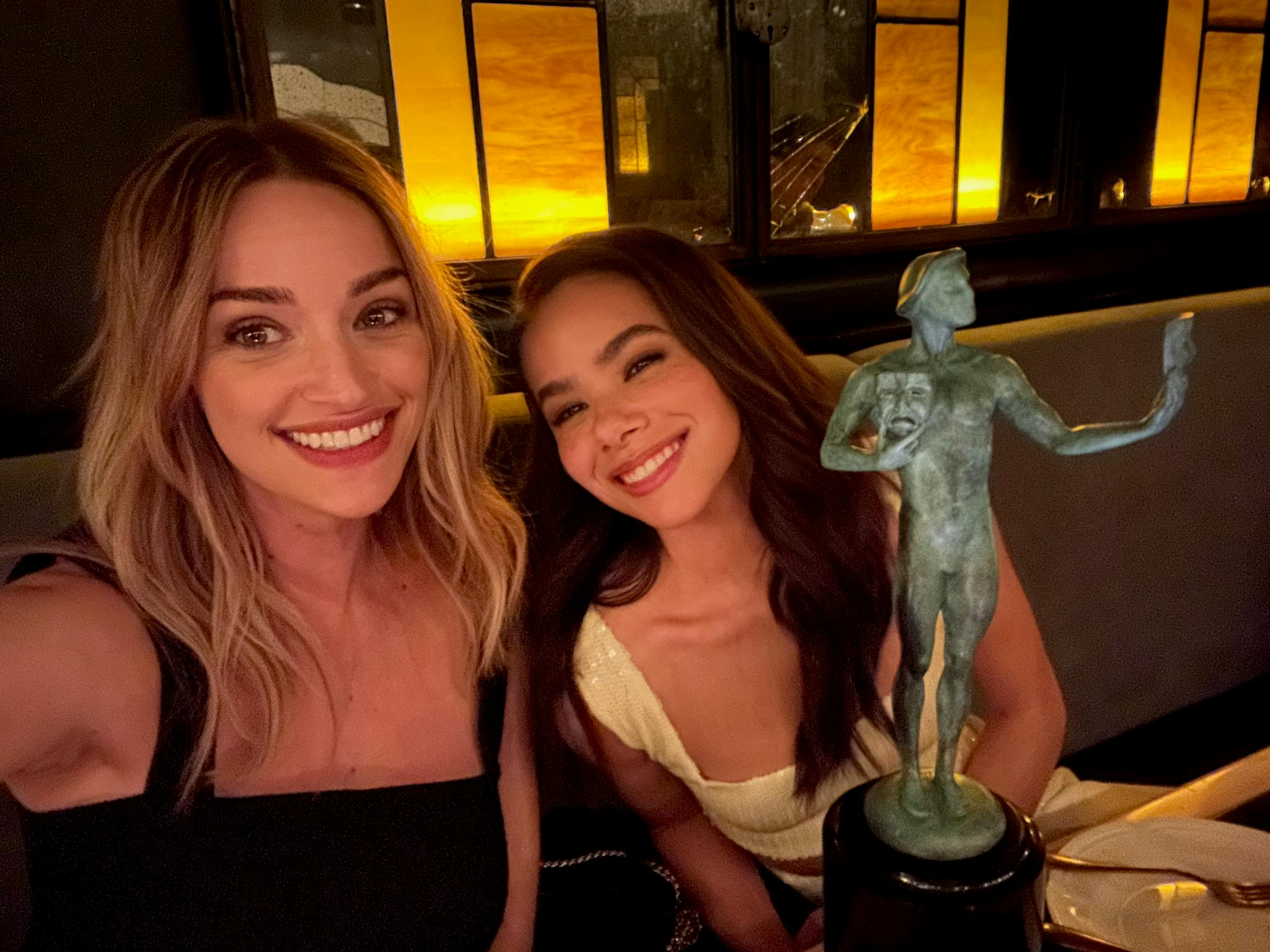  Brianne Howey and Antonia Gentry pose next to a small green statue in this cute selfie.