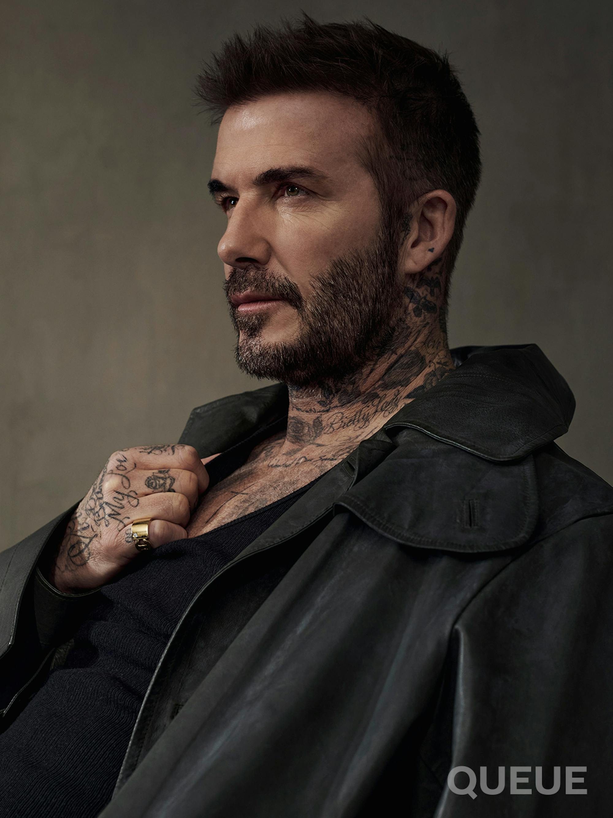 David Beckham wears a black jacket and looks off into the distance.