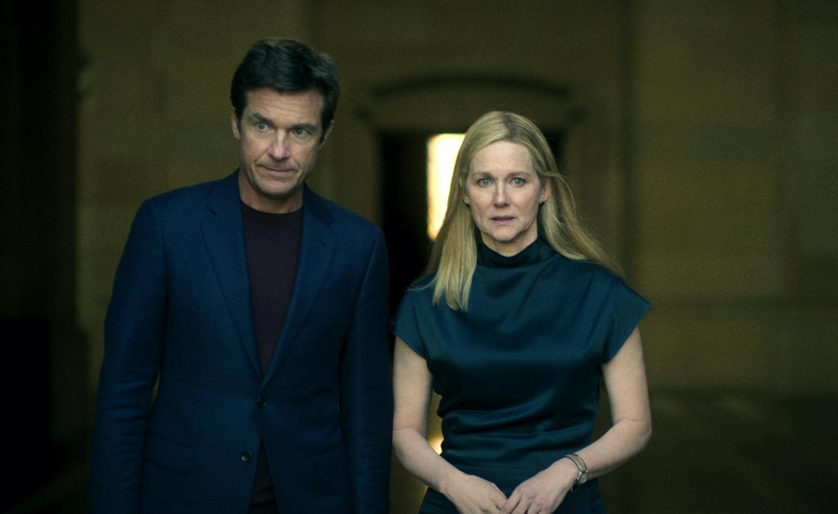 Jason Bateman and Laura Linney wear navy and look solemn.