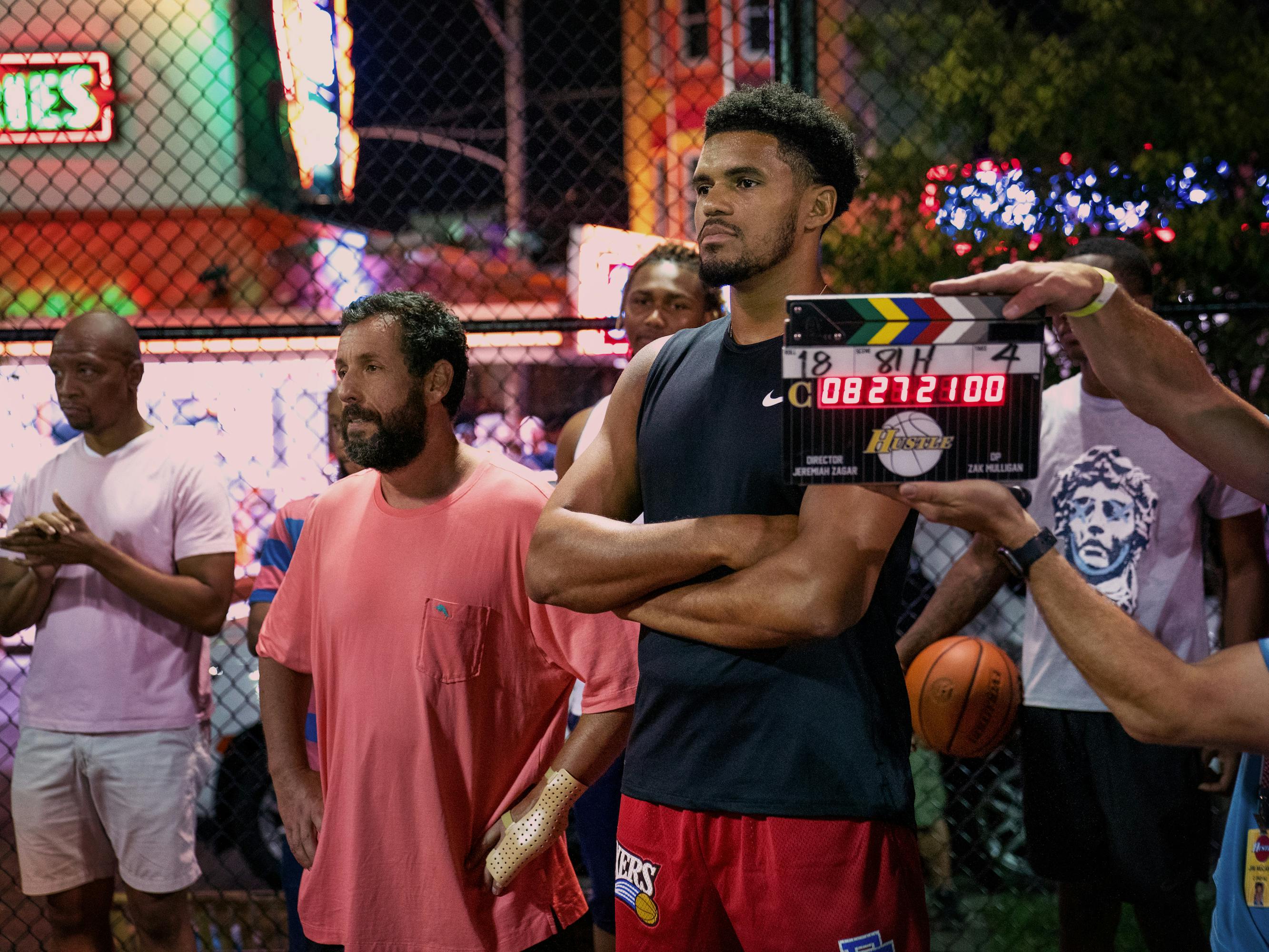 Adam Sandler and Tobias Harris stand around with other NBA stars.