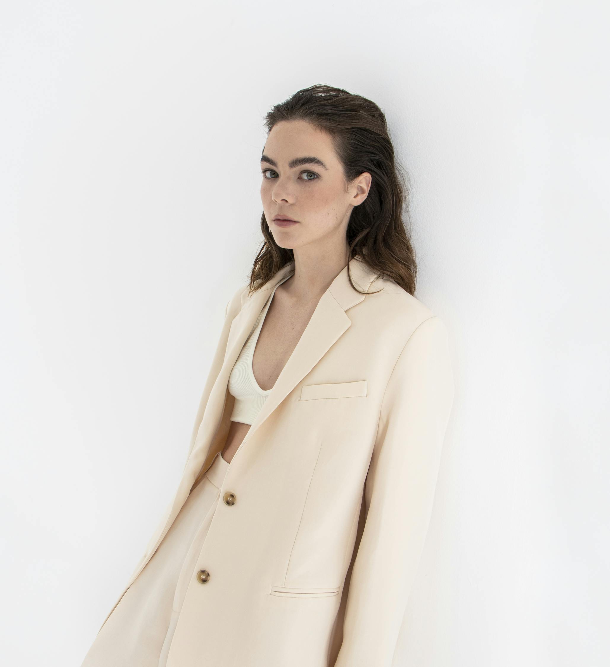 Ximena Lamadrid wears a beige suit and white top.