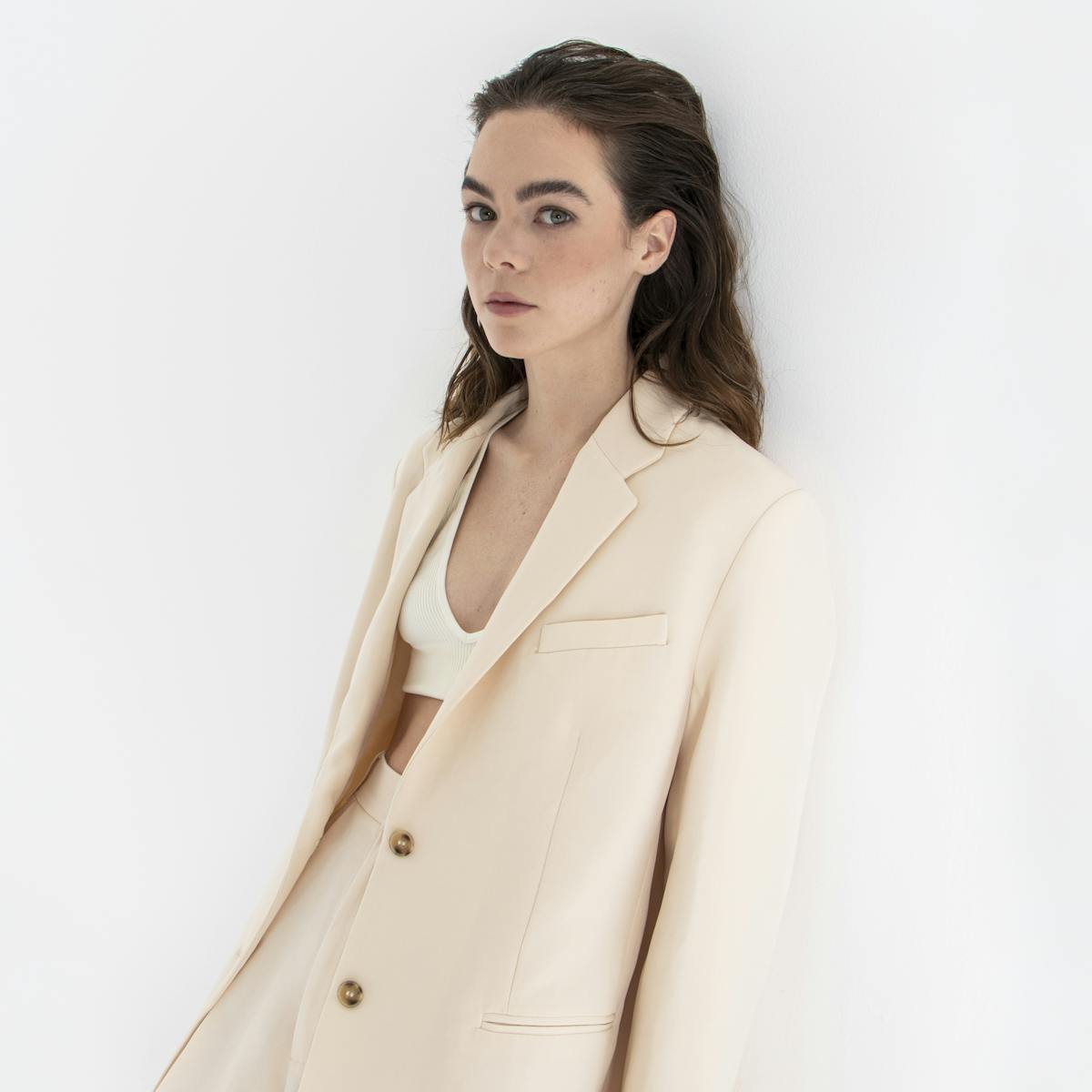 Ximena Lamadrid wears a beige suit and white top.