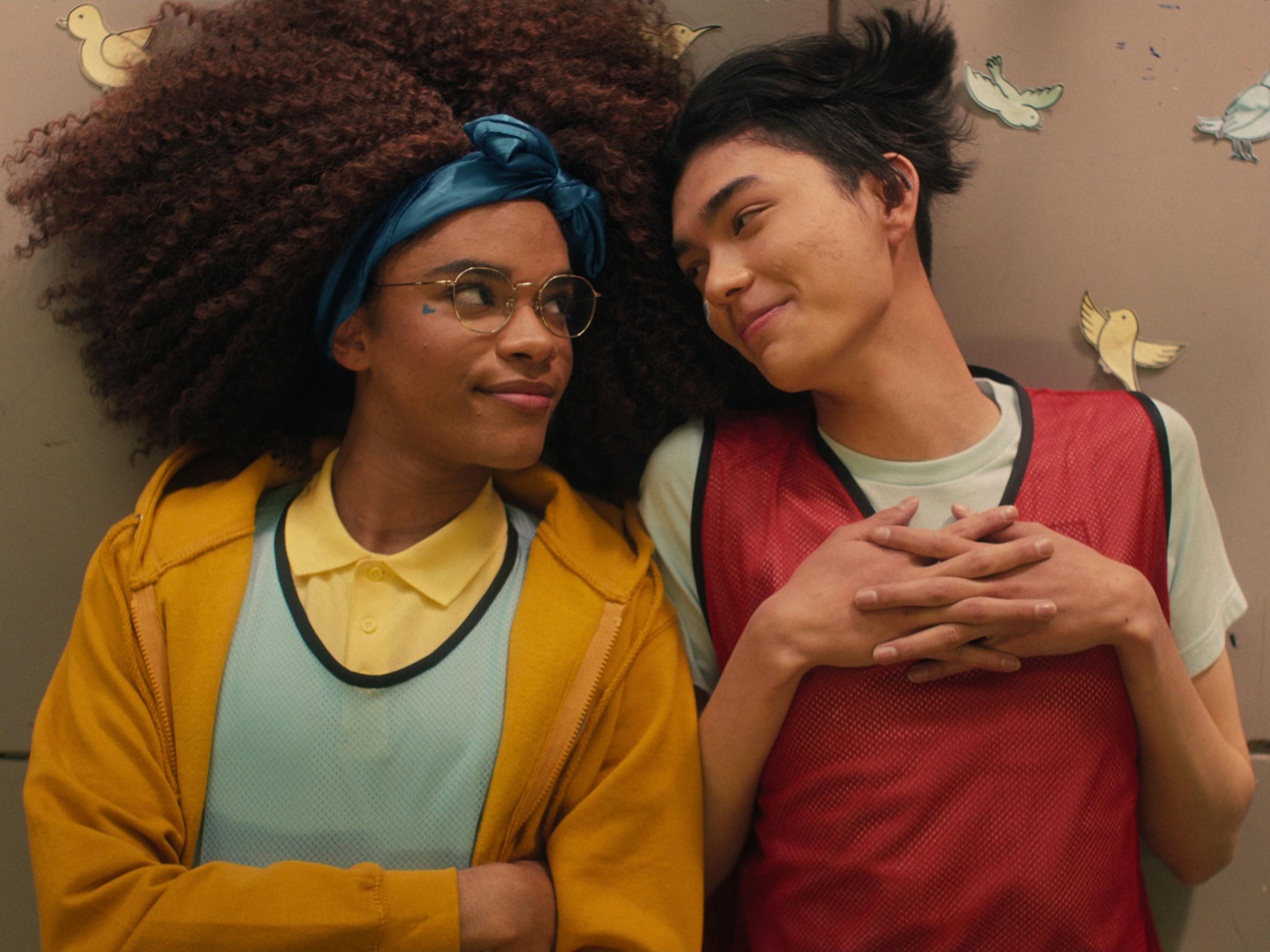 Elle Argent (Yasmin Finney) and Tao Xu (William Gao) lie together.