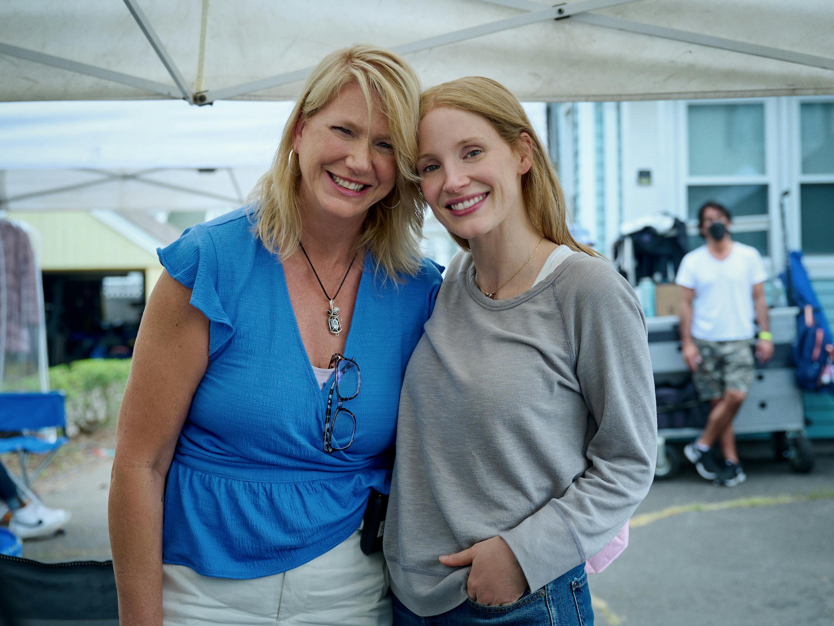 Amy Loughren and Jessica Chastain stand together under a tent.