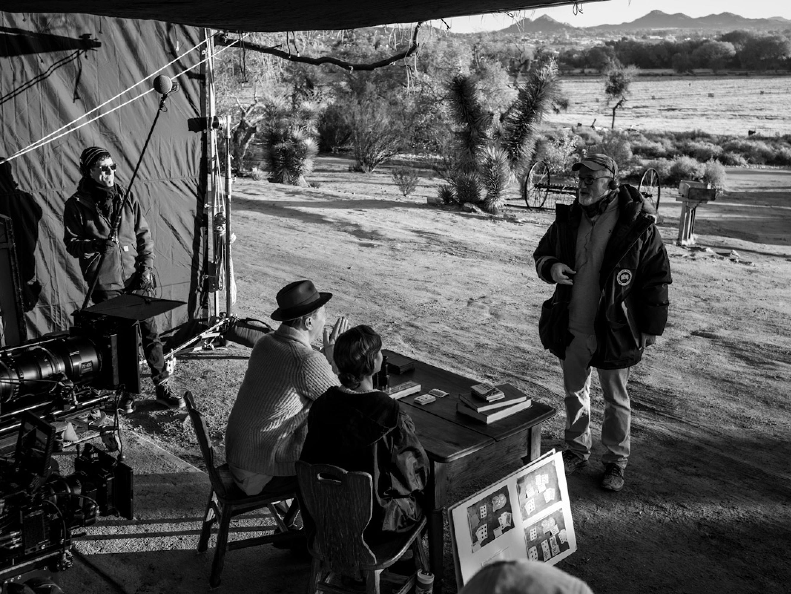 Fincher stands in front of a desert backdrop, across a small desk where Oldman and Collins are seated in costume as Herman Mankiewicz and his secretary, Rita Alexander.