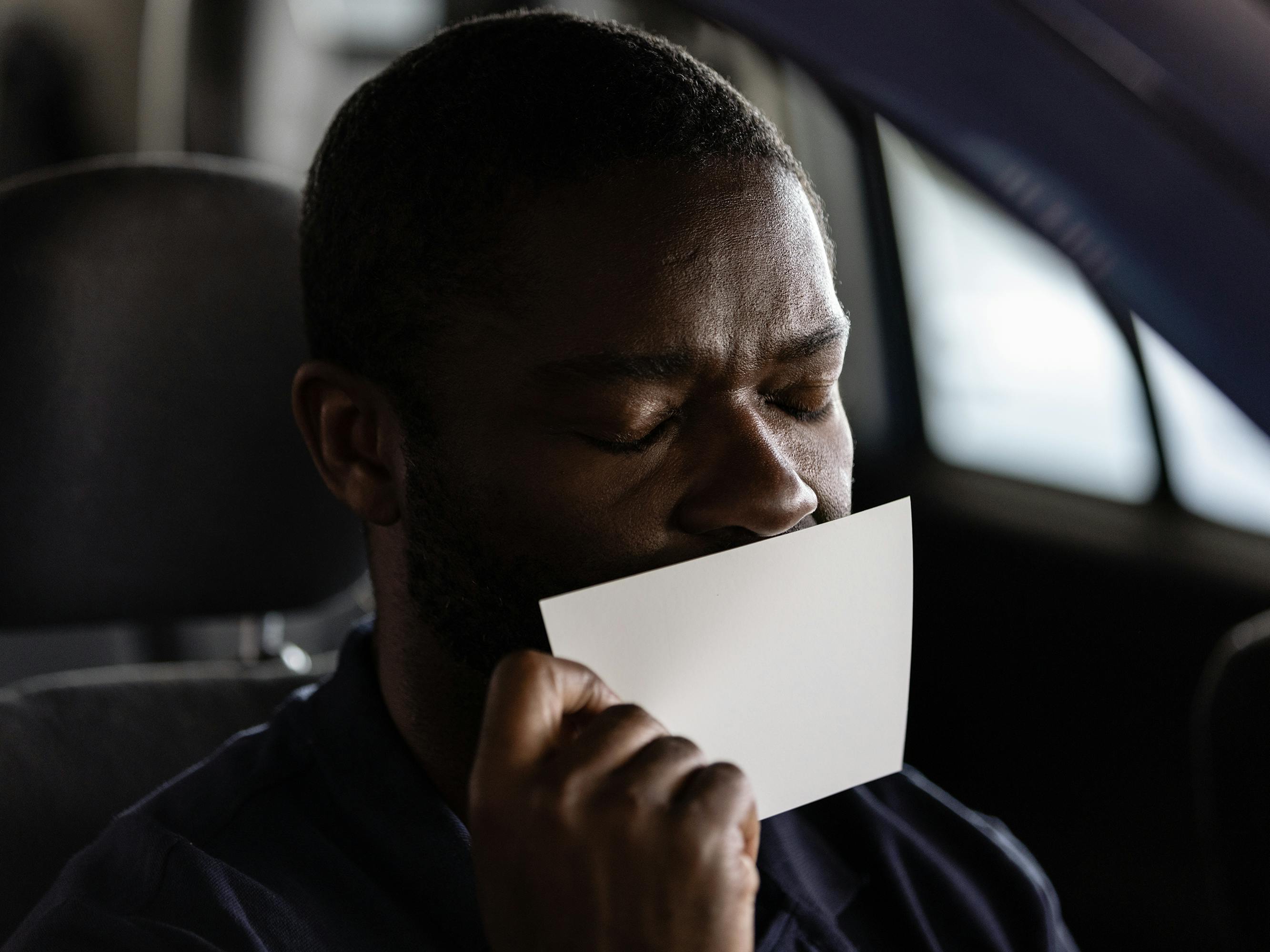 Dayo (David Oyelowo) kisses a white piece of paper.