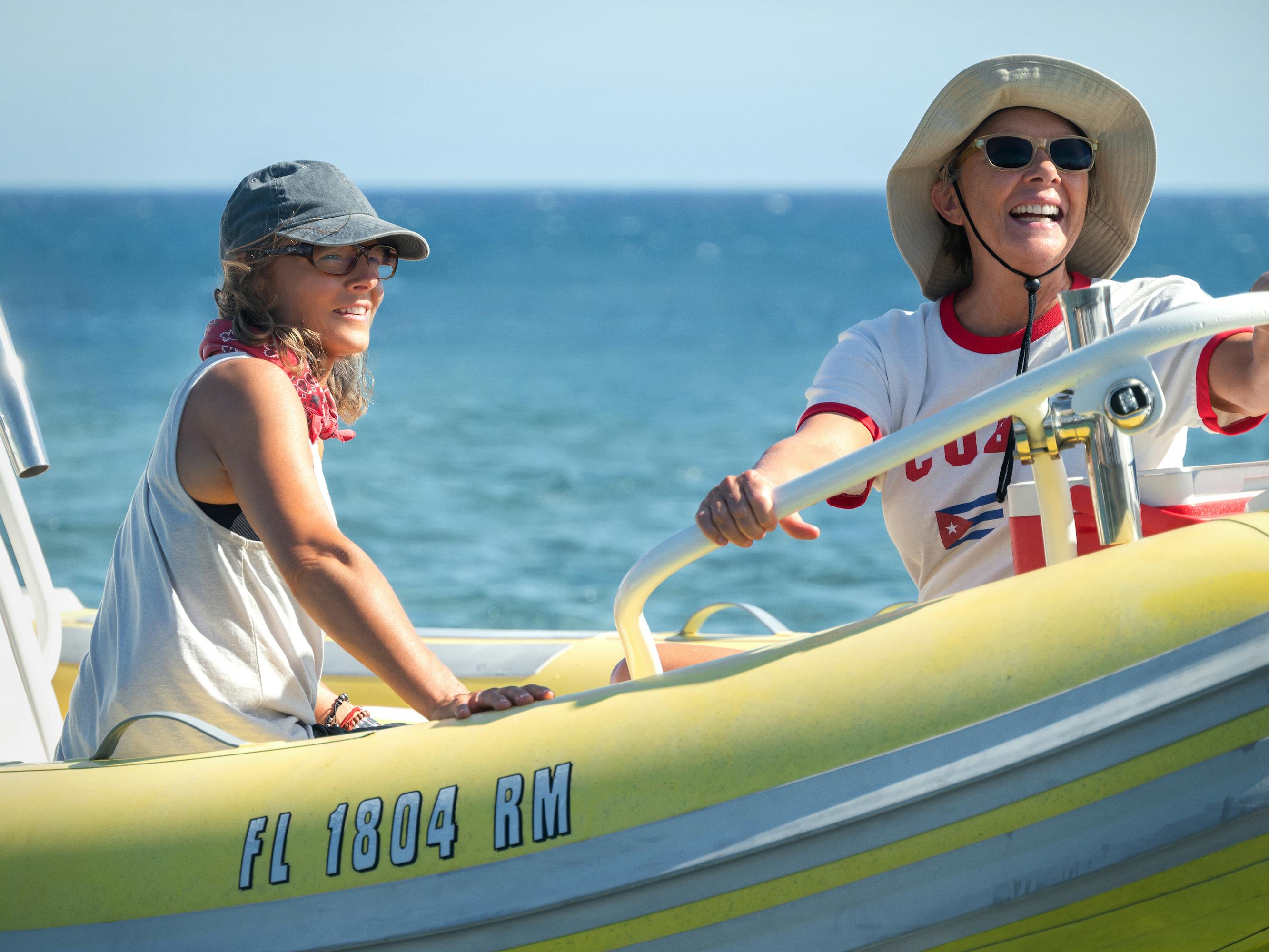 Bonnie Stoll (Jodie Foster) and Diana Nyad (Annette Bening) sit in a yellow boat on a sunny day.