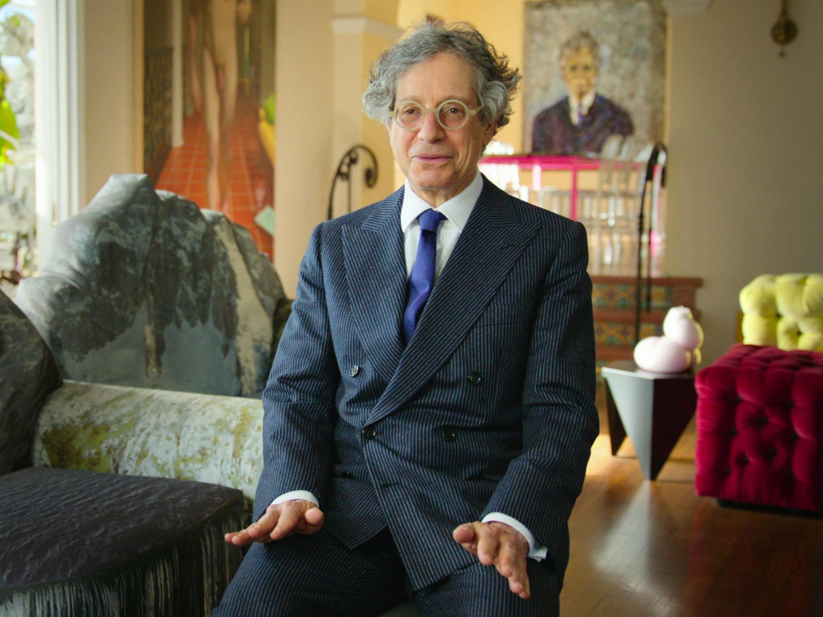 Jeffrey Deitch wears a double breasted suit and blue tie.