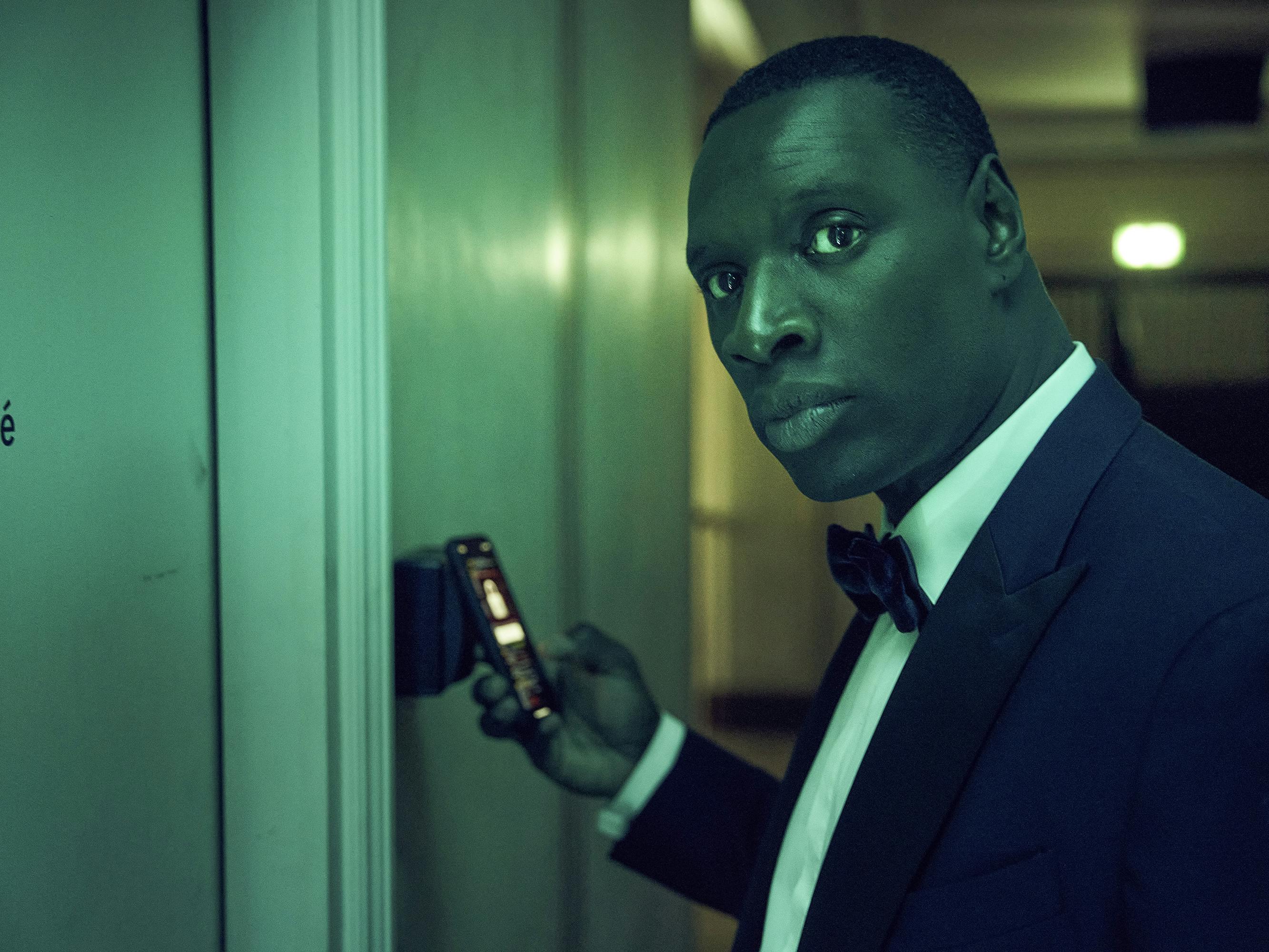 Assane Diop (Omar Sy) looks suave and sneaky in a black tux and bowtie. 