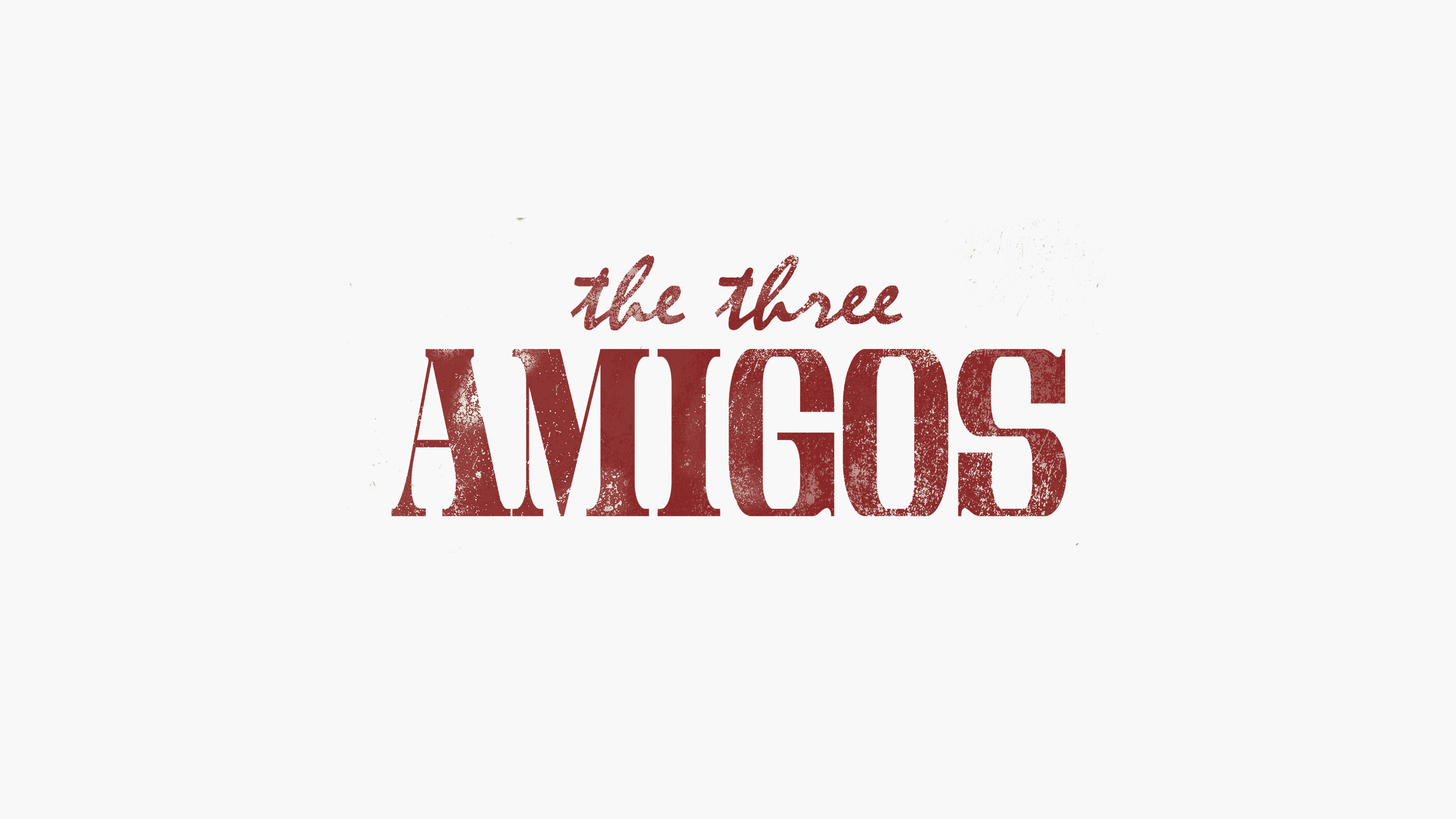 In faded red, text reads 'the Three Amigos' against a white background.