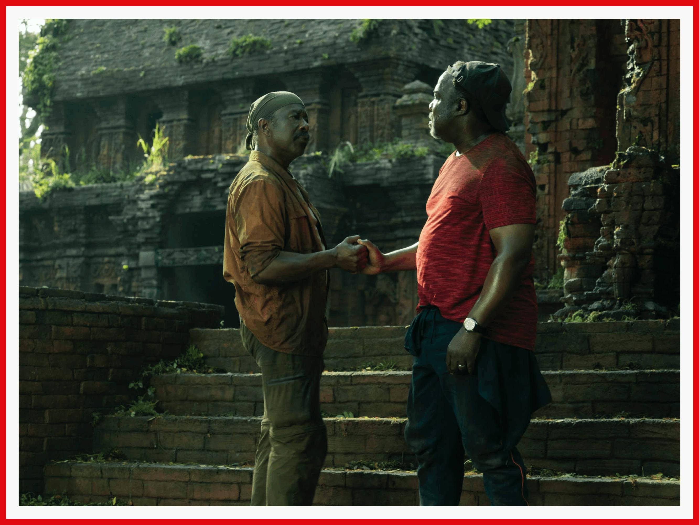 Looking worn from their characters’ quest, Clarke Peters and Isiah Whitlock Jr. dap in front of stone ruins