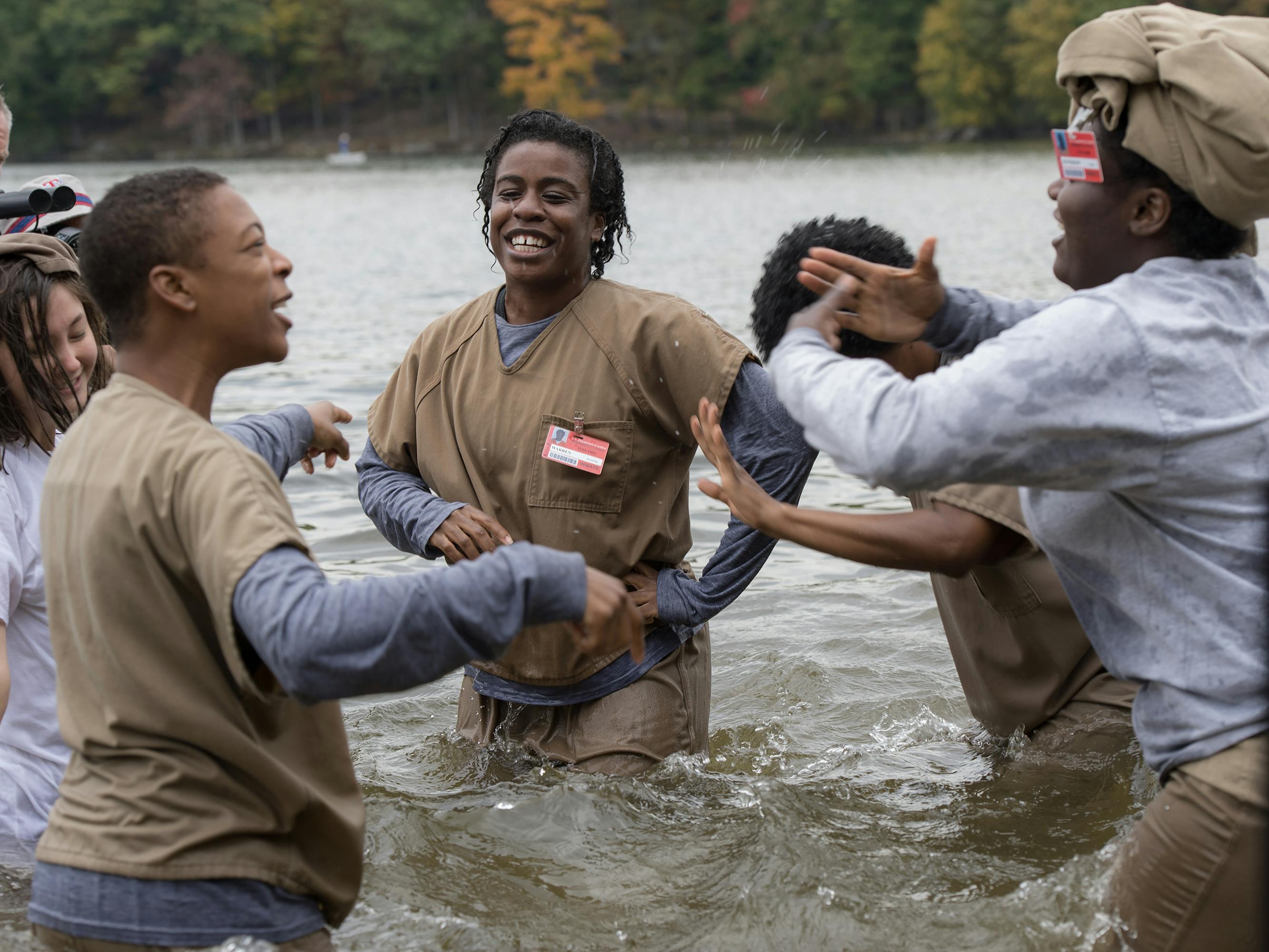 Suzanne “Crazy Eyes” Warren (Uzo Aduba) splashes around in a river with four other women.