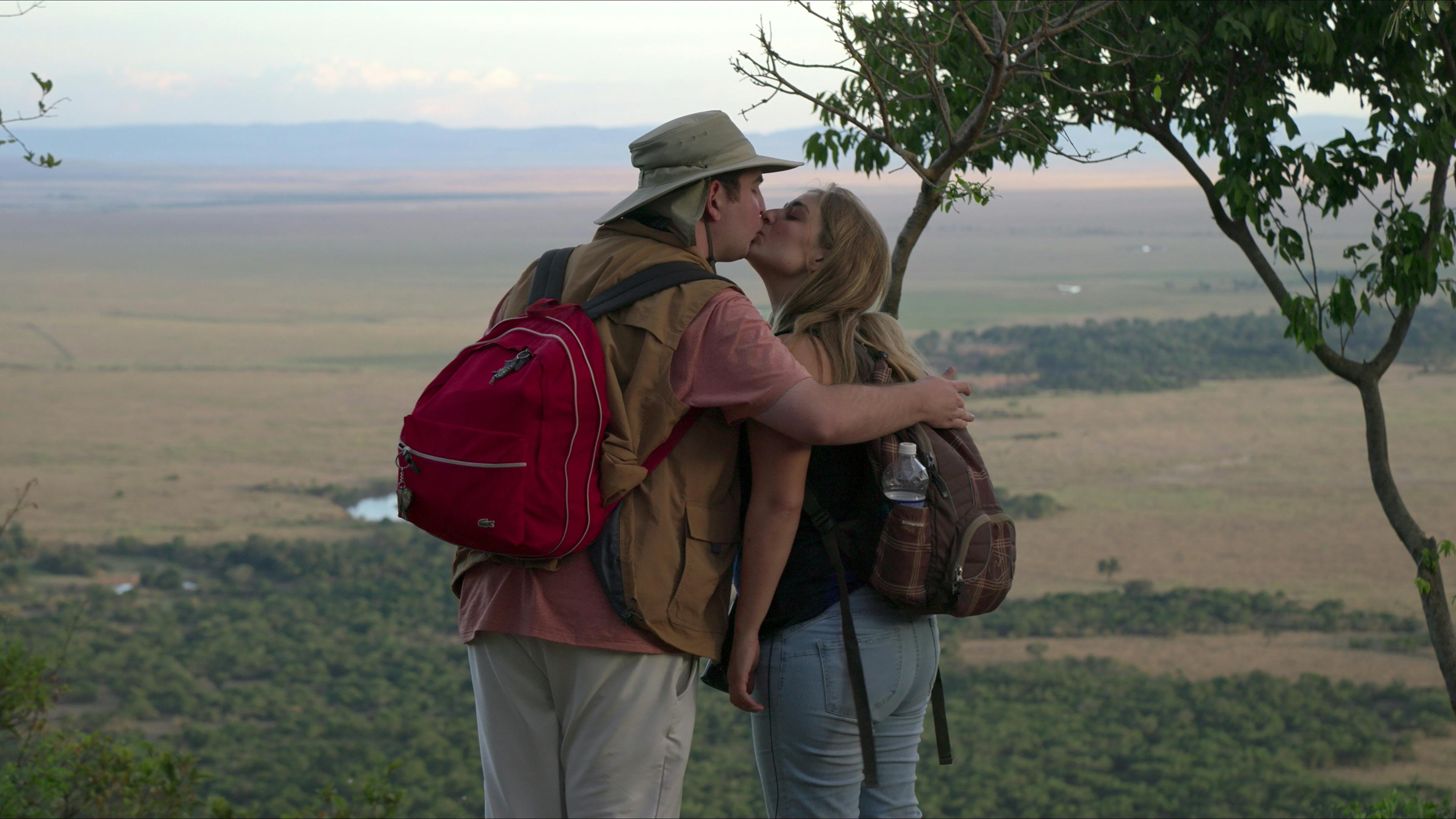 David and Abbey kiss against the beautiful background of the Maasai Mara.