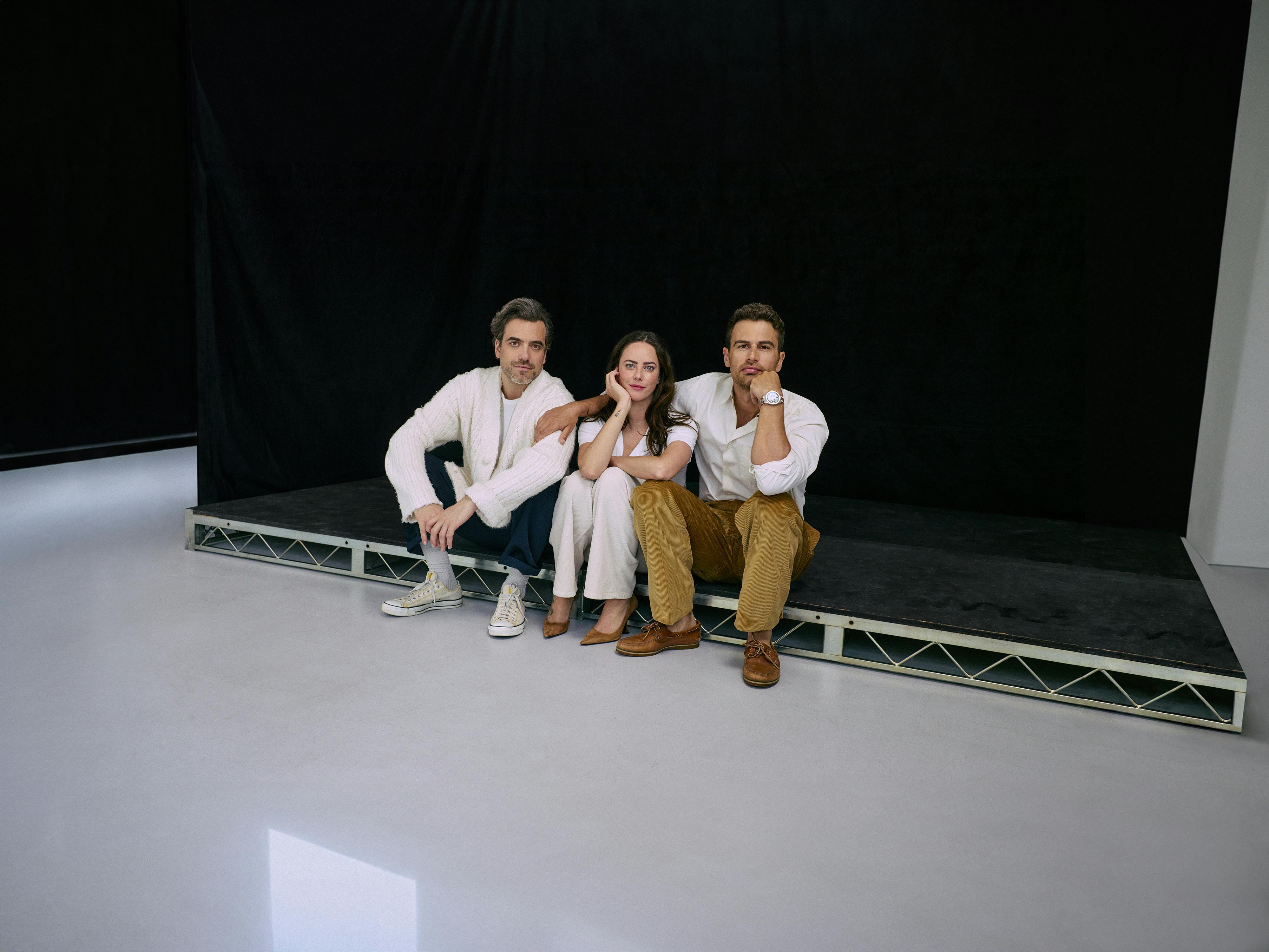 Daniel Ings, Kaya Scodelario, and Theo James sit on a black stage together.