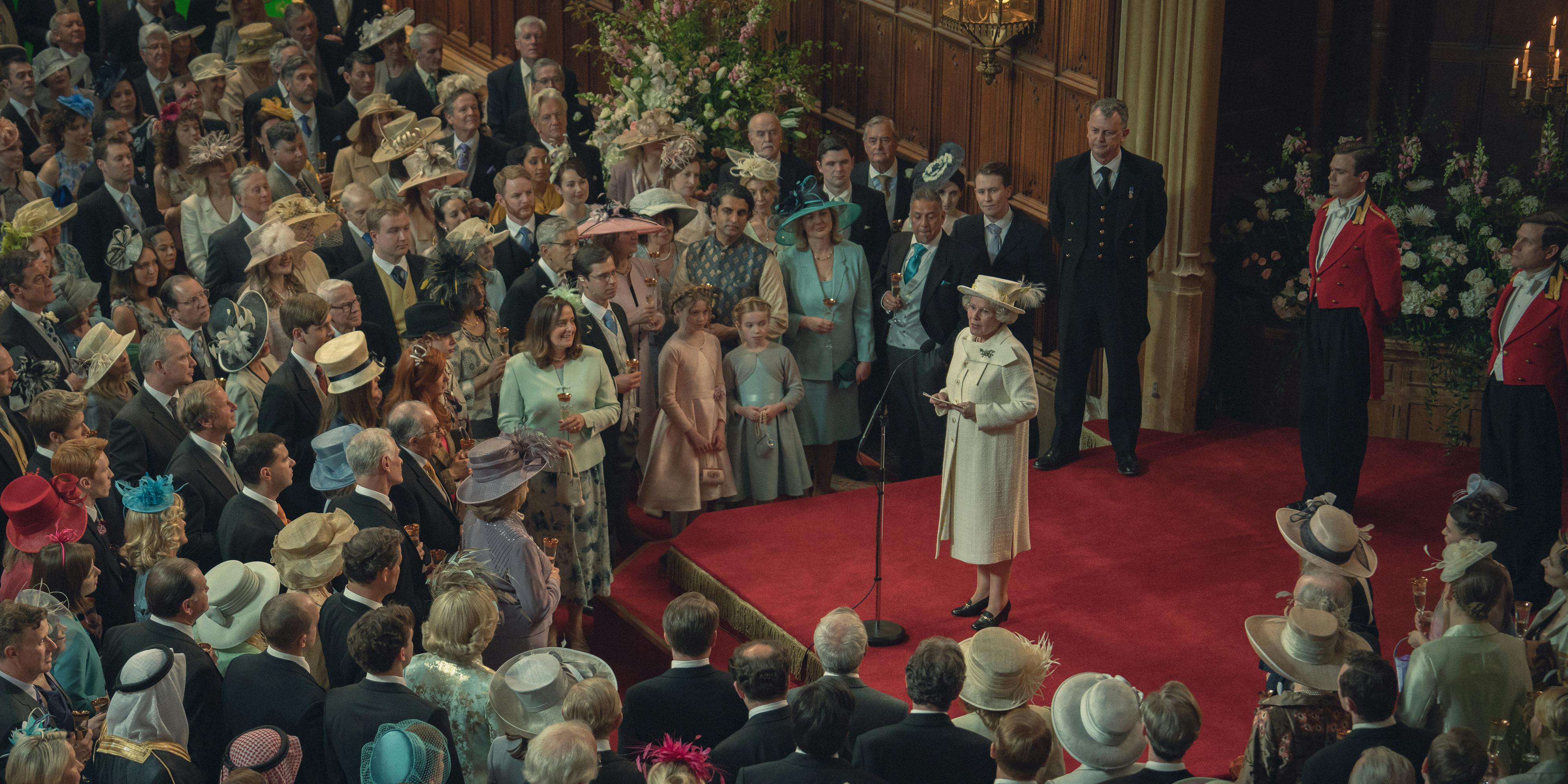 Queen Elizabeth (Imelda Staunton) addresses a huge crowd wearing fabulous hats.