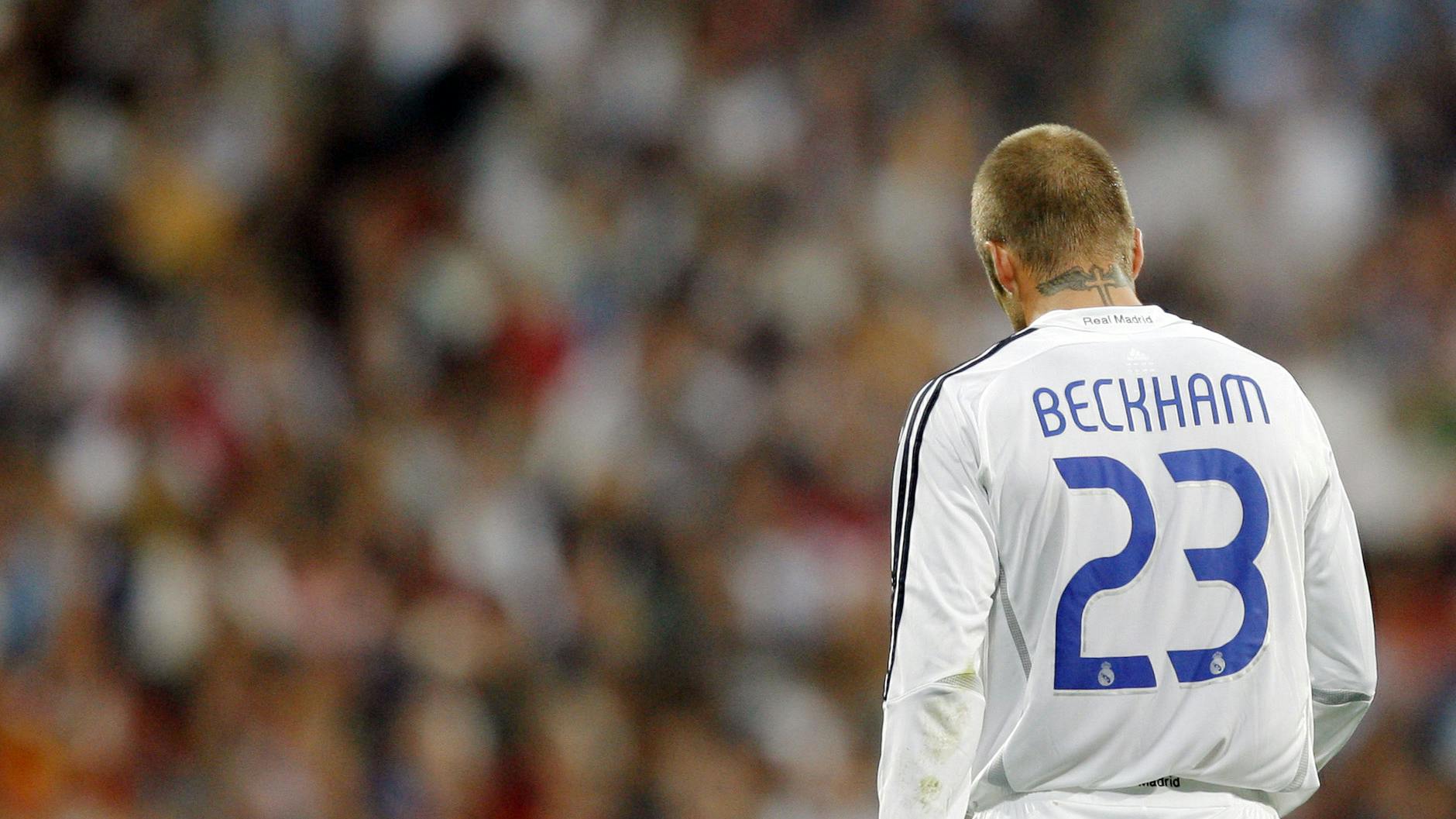 David Beckham wears a 23 jersey against a blurry crowd.