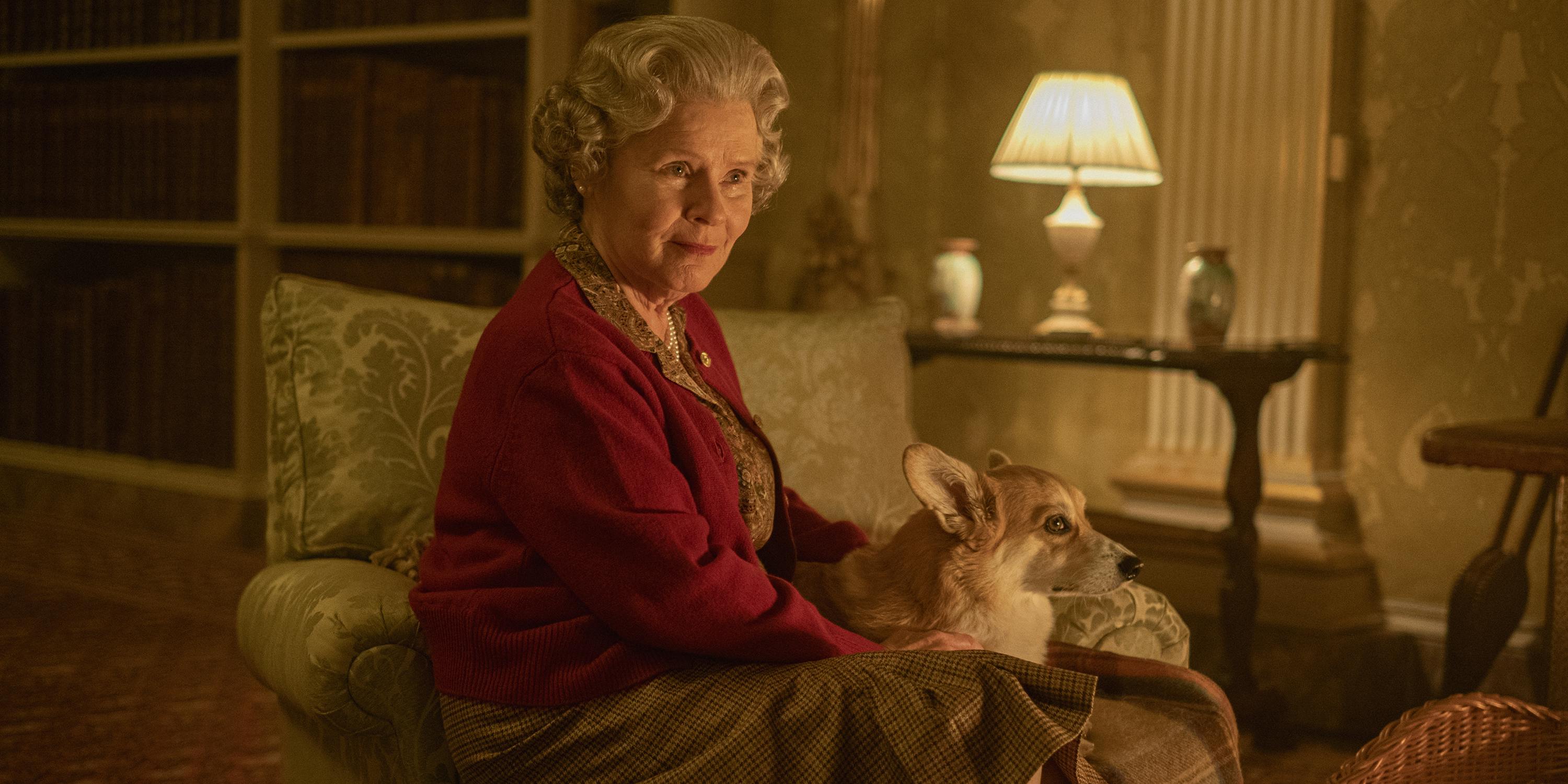 Queen Elizabeth (Imelda Staunton) sits in a cozy room with her corgi.