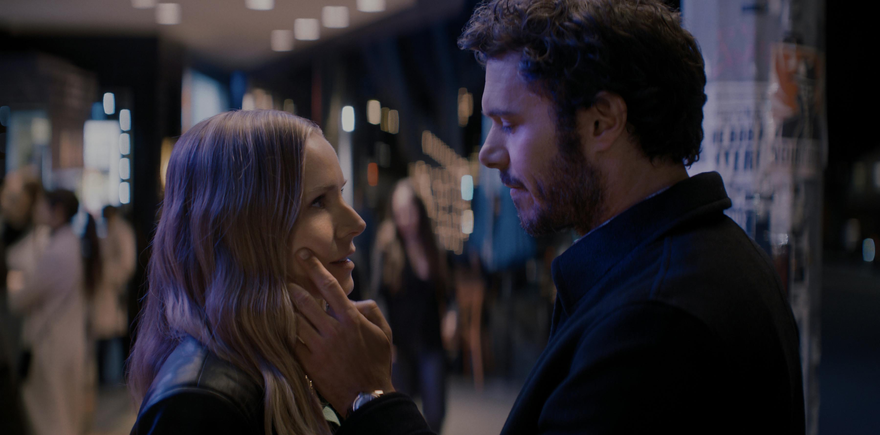 Noah (Adam Brody) brings his hand to Joanne's (Kristen Bell) cheek in this tender moment.