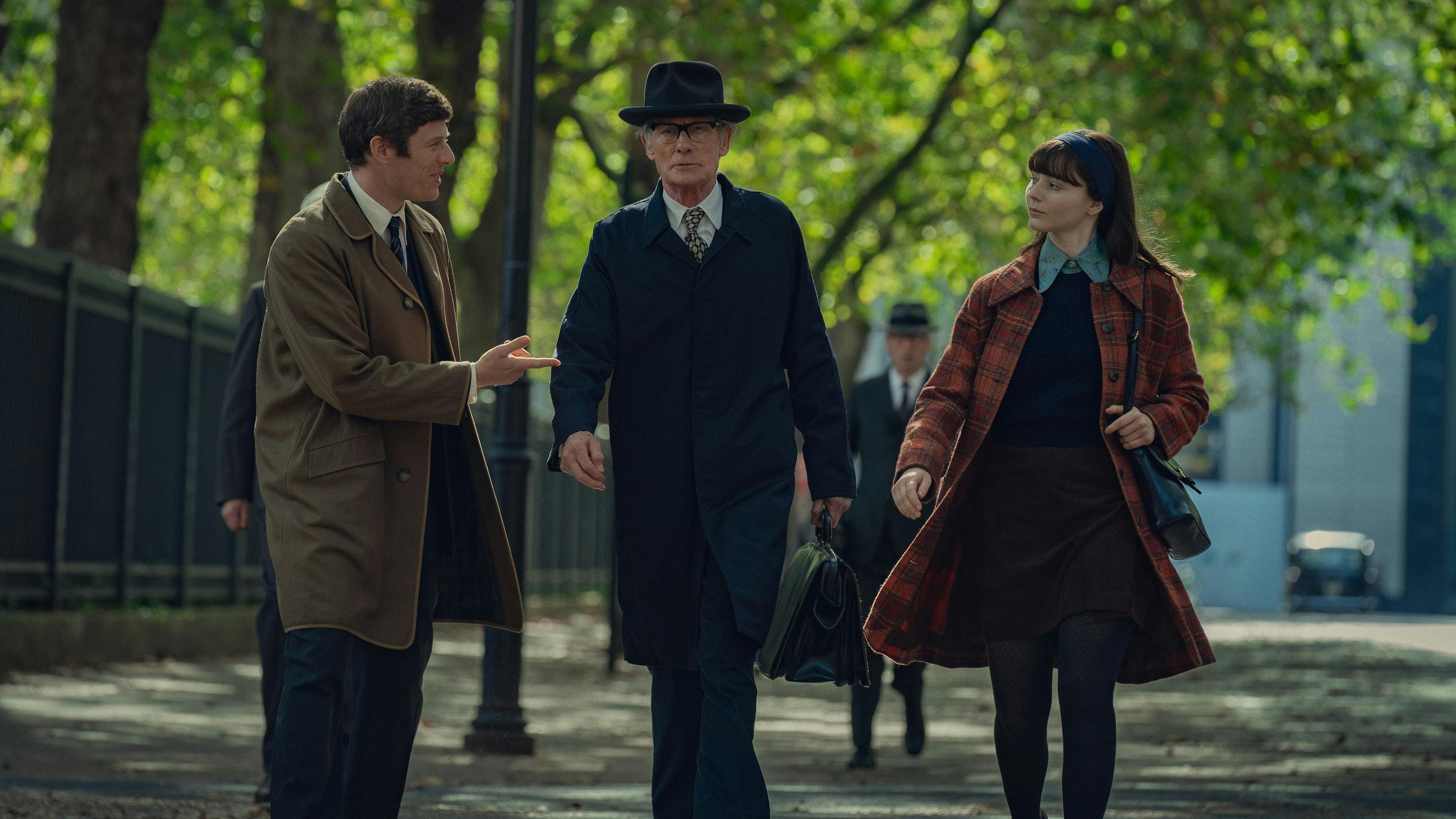 Robert Edwards (James Norton), Patrick Steptoe (Bill Nighy), and Jean Purdy (Thomasin McKenzie) walk through a park.