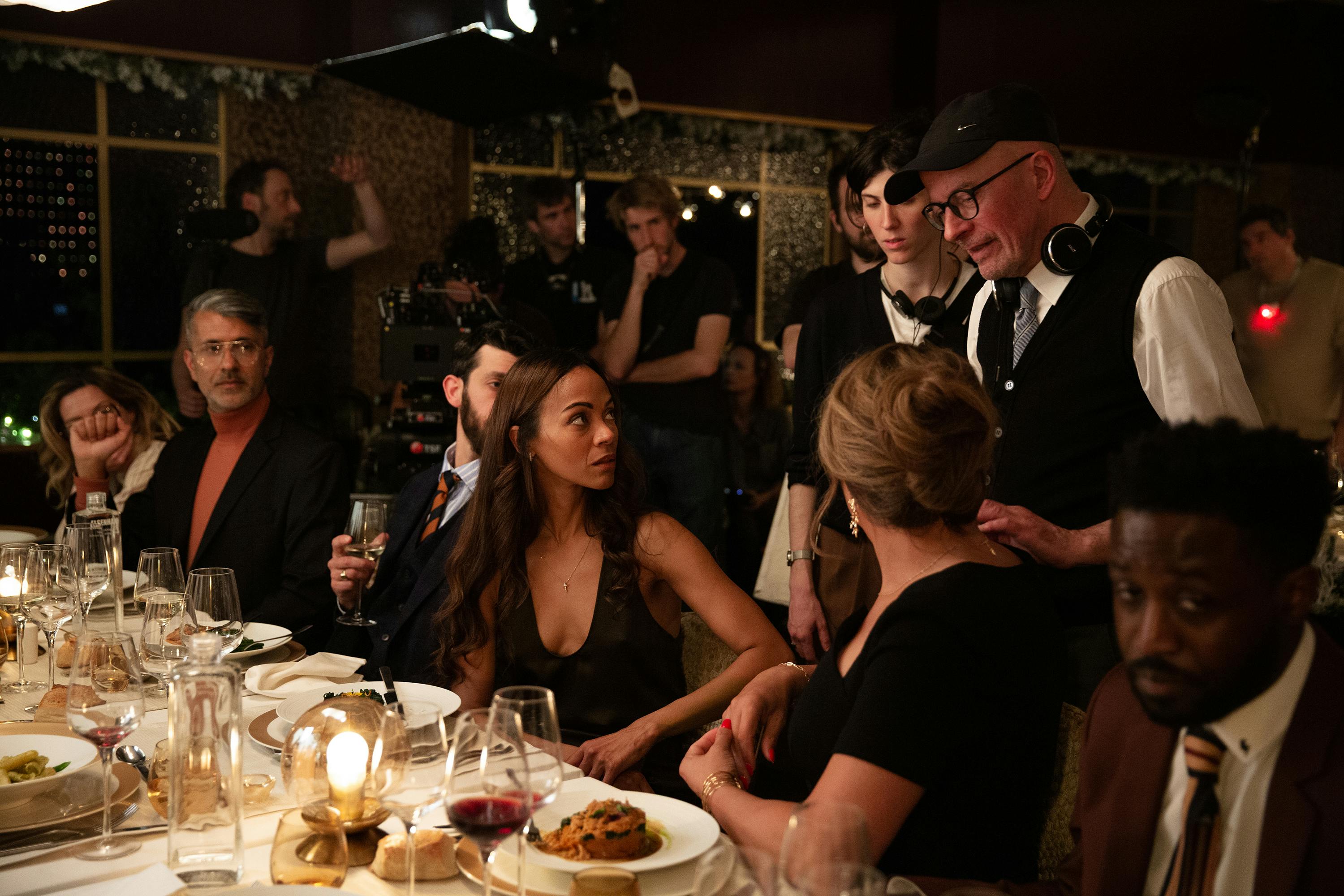 Zoe Saldaña, Karla Sofía Gascón, and Jacques Audiard behind the scenes of Emilia Pérez.