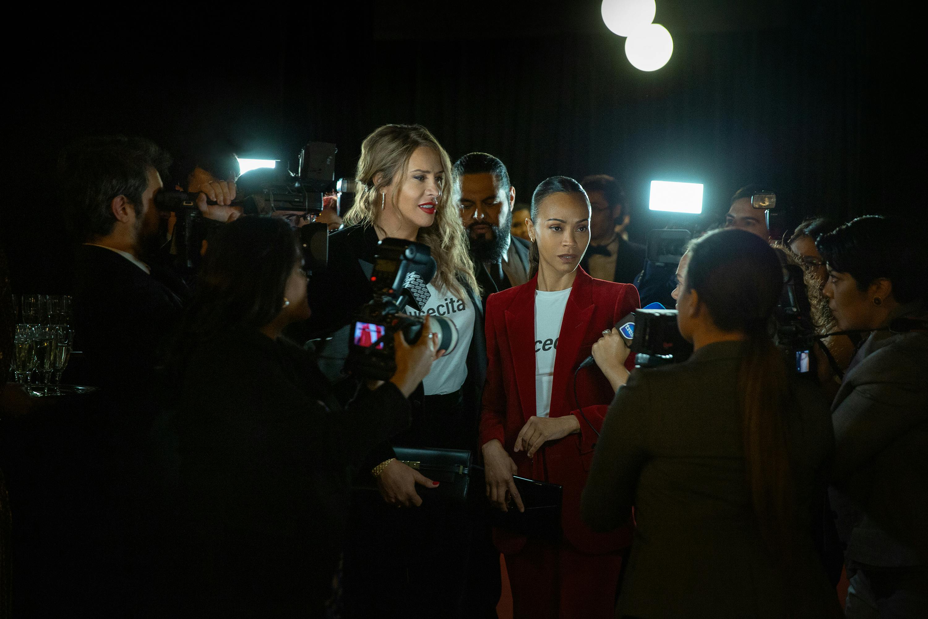 Emilia Pérez (Karla Sofía Gascón) and Rita (Zoe Saldaña) answer questions from the press.