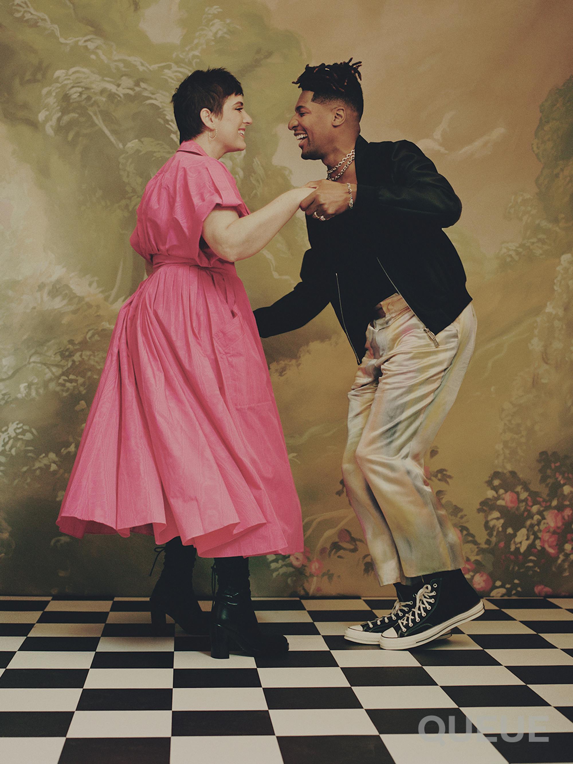 Suleika Jaouad and Jon Batiste dance on a black-and-white checkered ground.