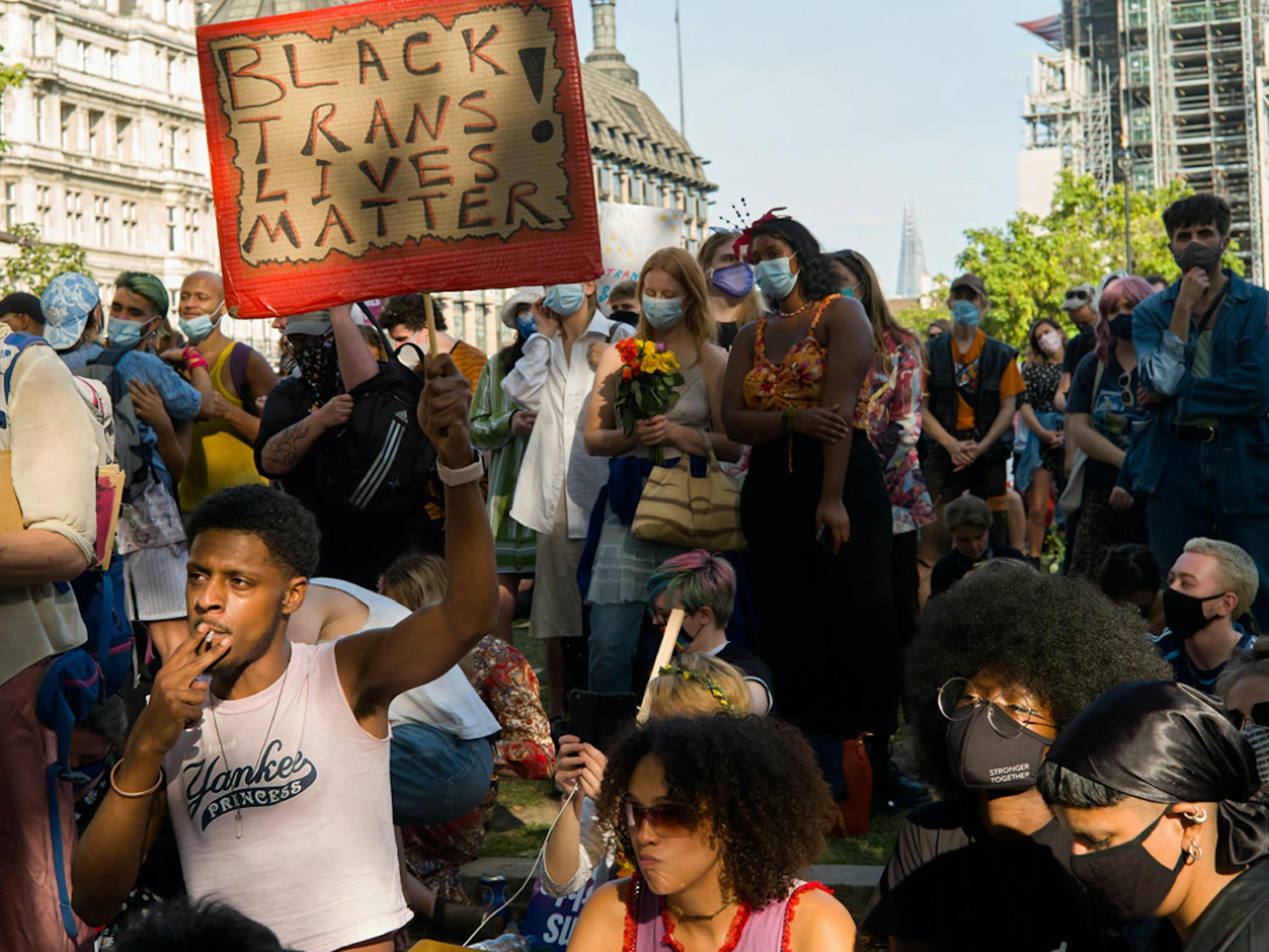 An activist holds up a Black Trans Lives Matter sign at a Trans+ Pride rally at Parliament Square in London on September 12, 2020