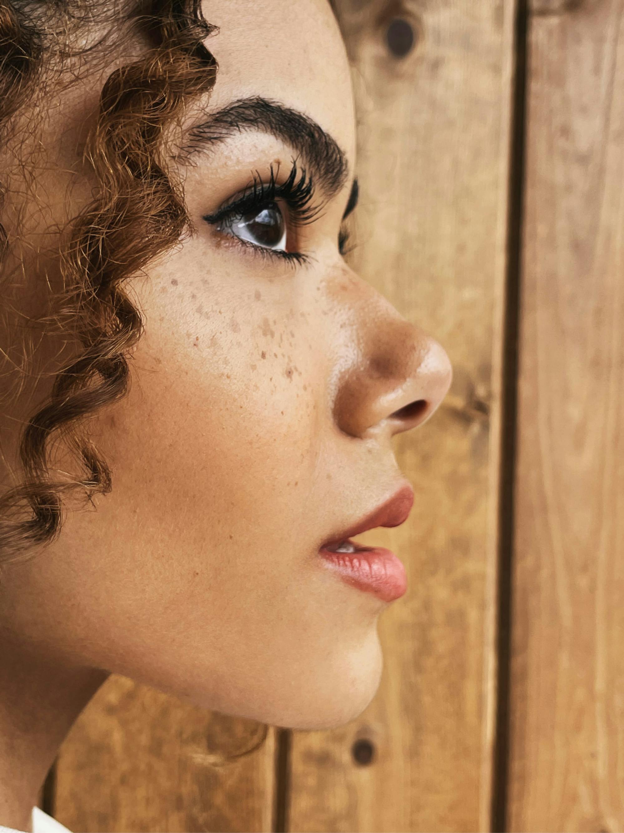 A profile shot of Gentry against a wood background.