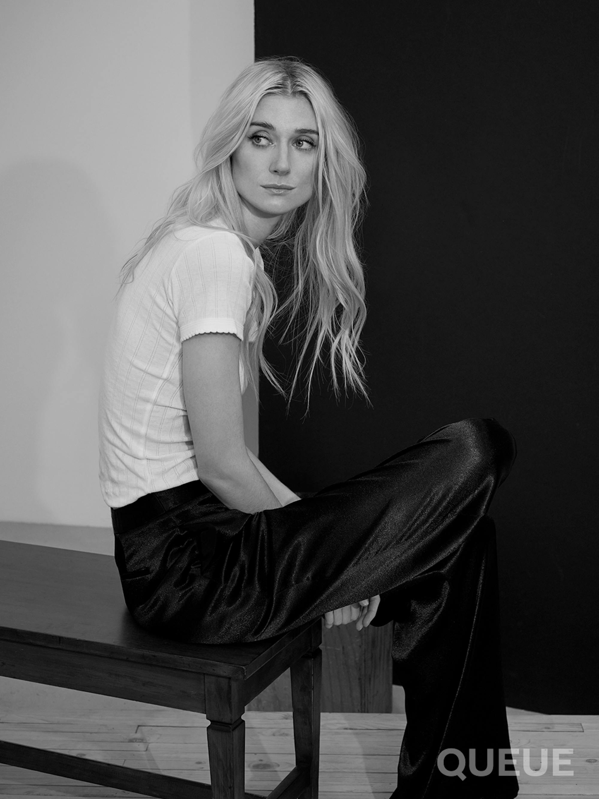 Elizabeth Debicki wears a white T-shirt and black velvet pants.