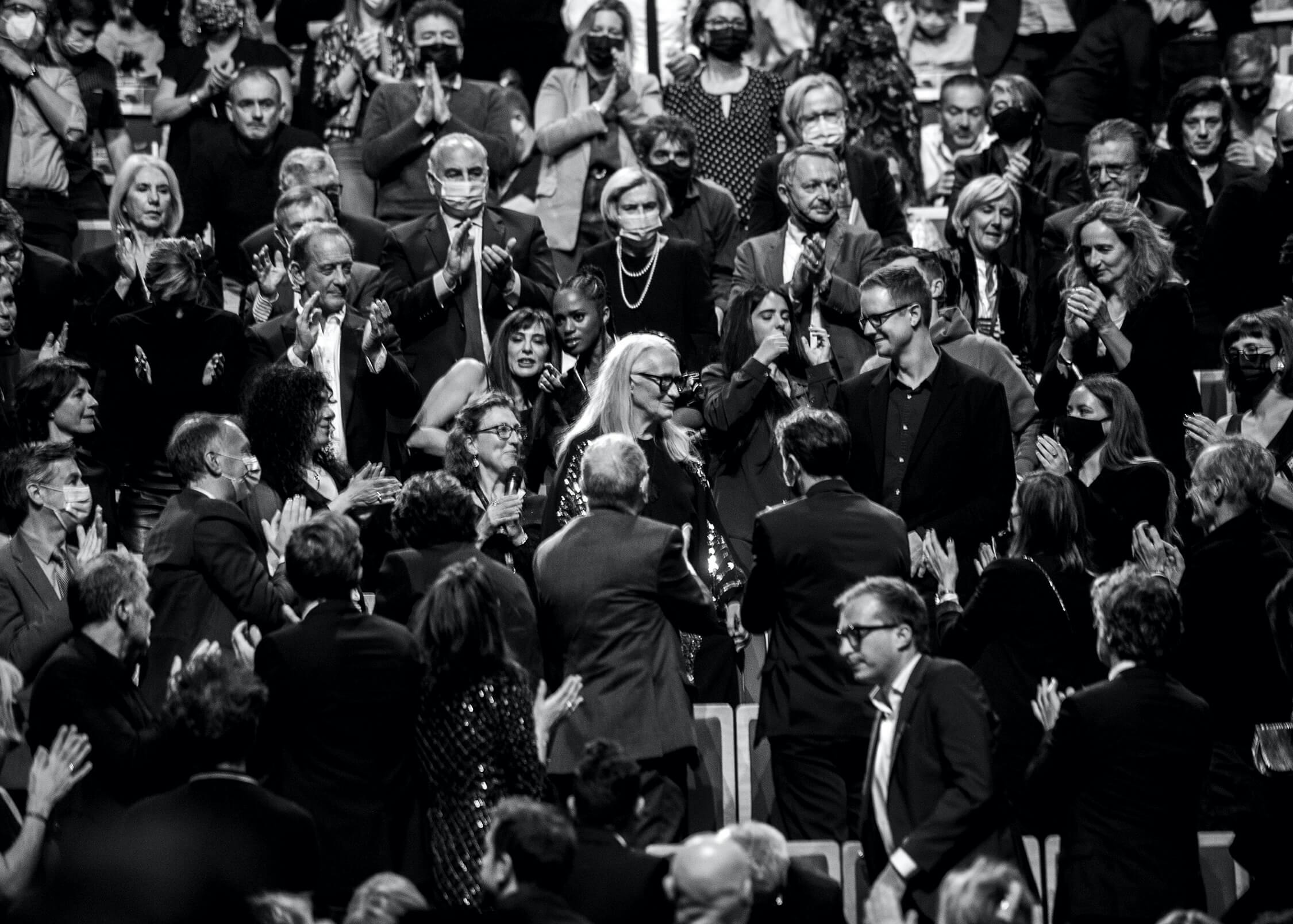 Jane Campion glows like the goddess she is in a sea of people clapping, smiling and cheering her on in this gorgeous black-and-white shot.