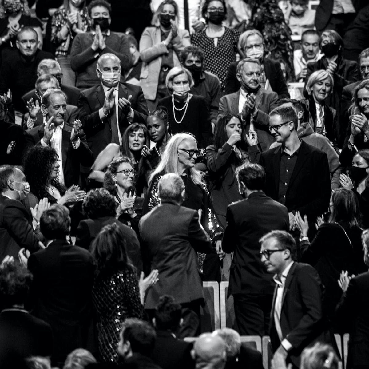 Jane Campion glows like the goddess she is in a sea of people clapping, smiling and cheering her on in this gorgeous black-and-white shot.