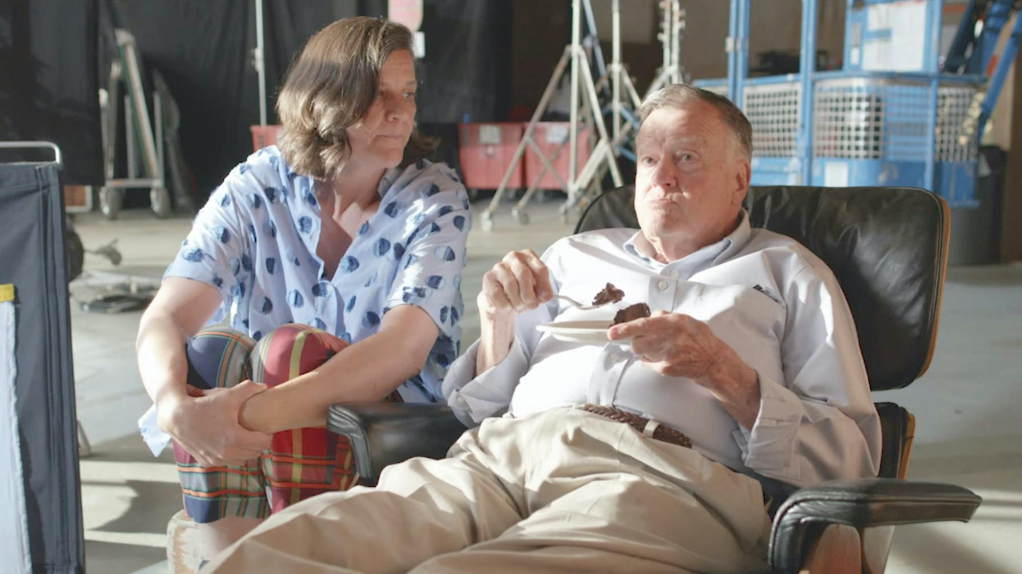 Kirsten Johnson sits with her father as he enjoys some chocolate cake.