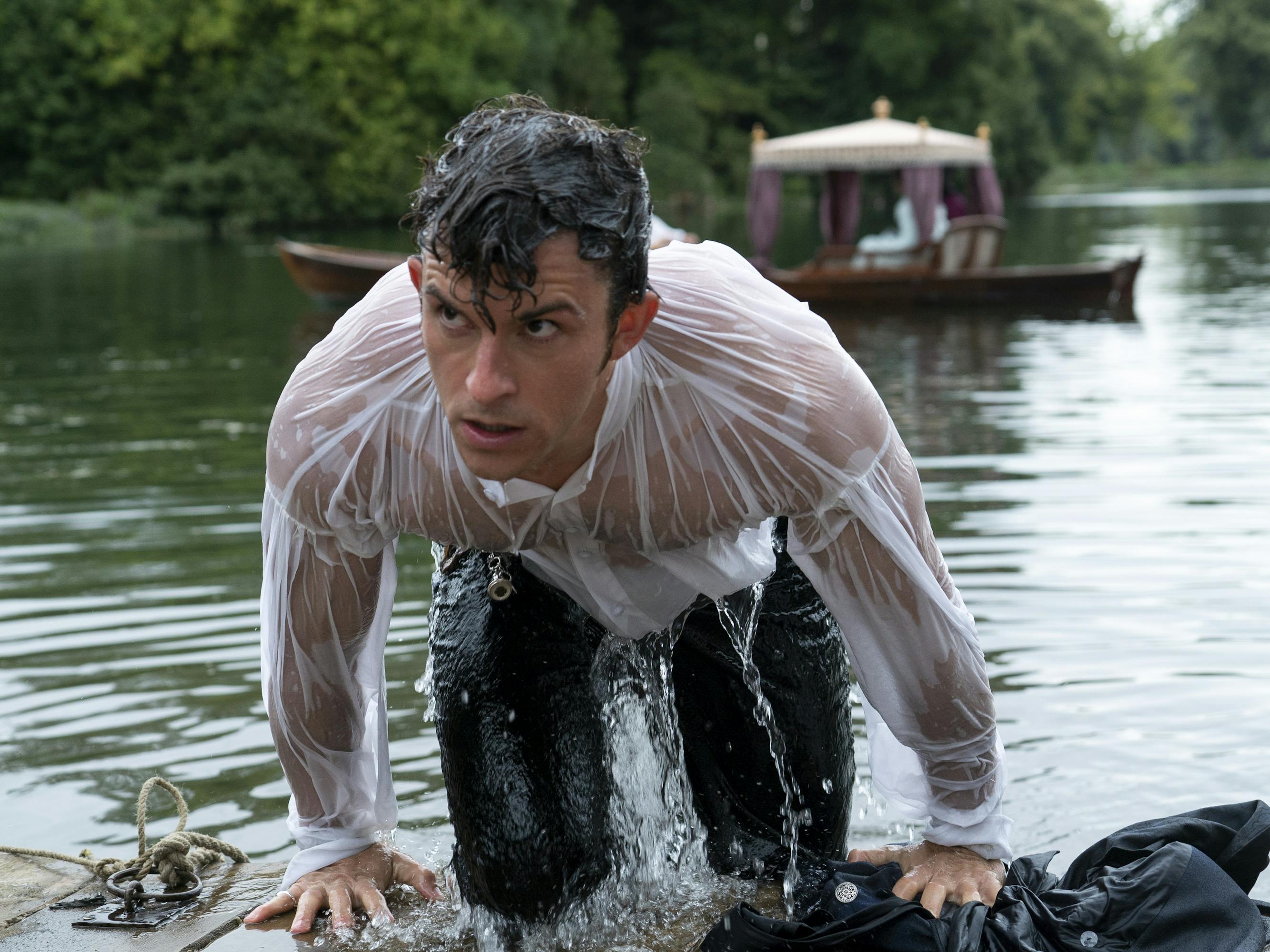 Anthony Bridgerton (Jonathan Bailey) wears a white shirt and dark pants, and has just fallen in the pond. SWOON!