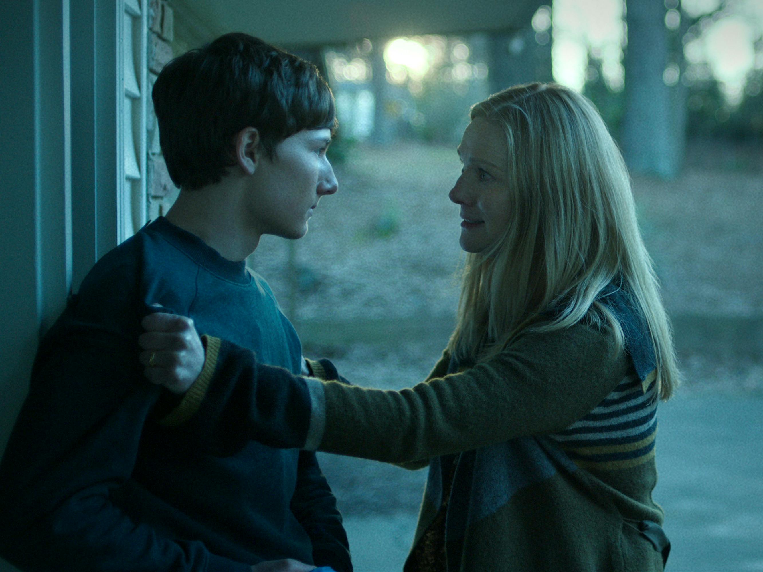 Jonah Byrde (Skylar Gaertner) and Wendy Byrde (Laura Linney) have a confrontation outside a building in the classic grey Ozark light.