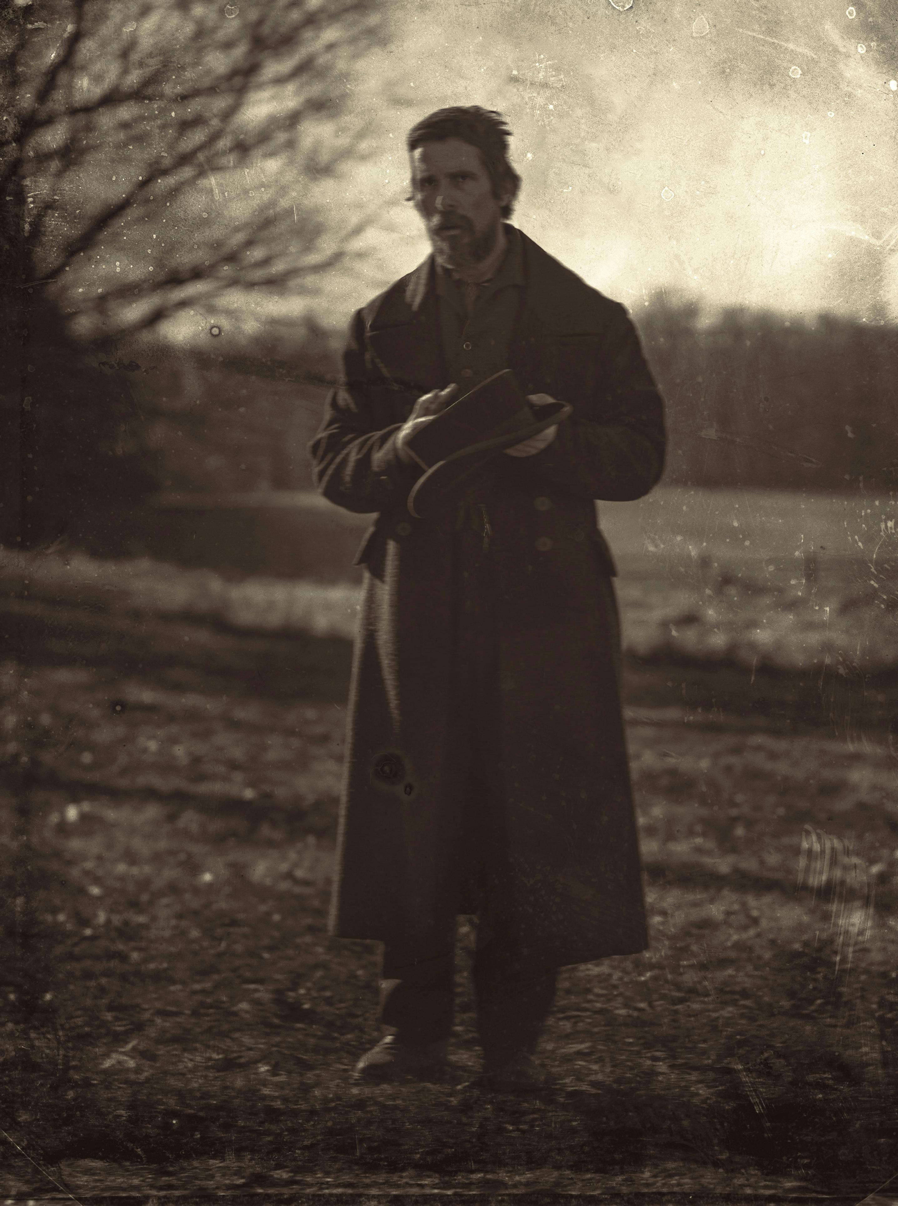 Augustus Landor (Christian Bale) wears a long coat in this sepia-toned picture.