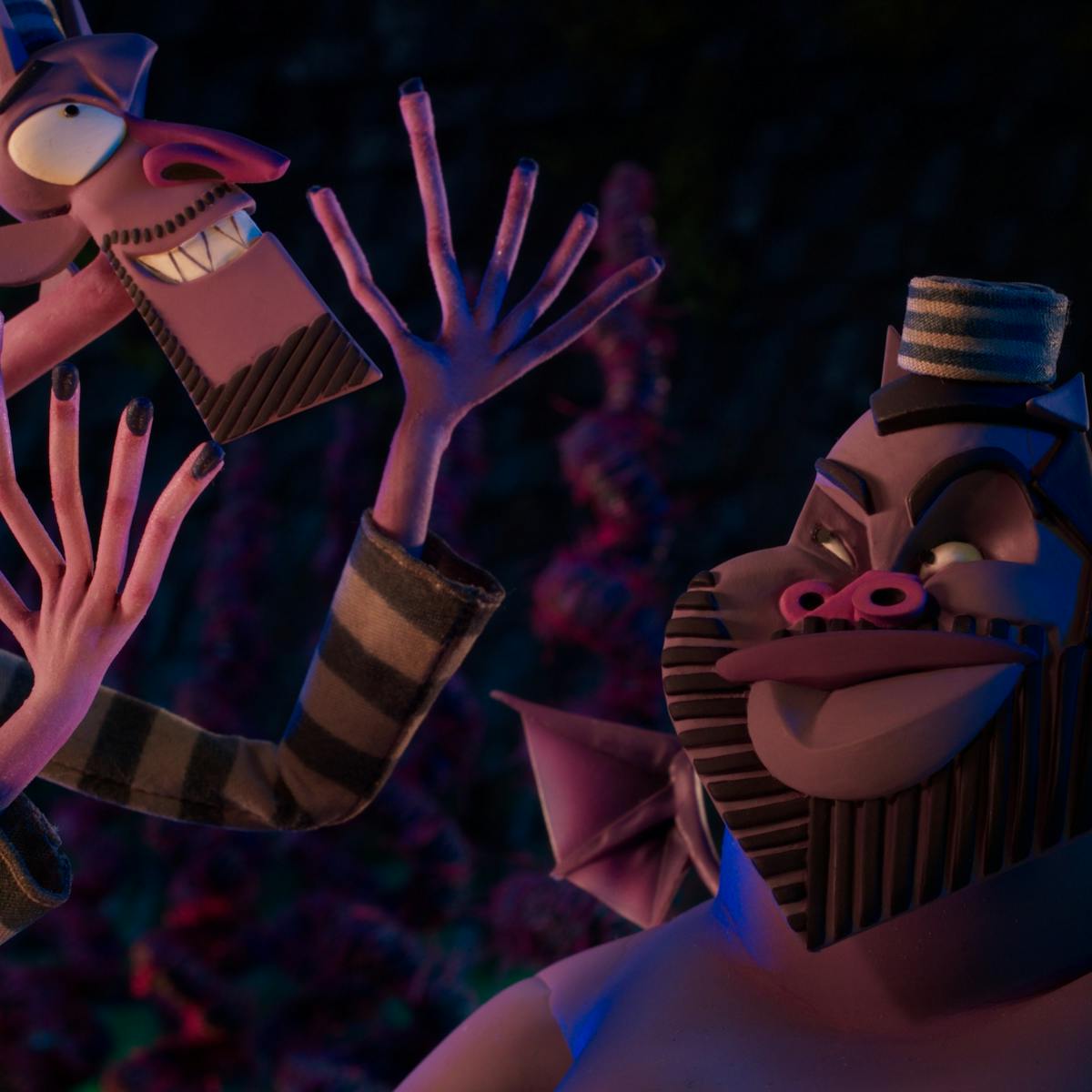 Wendell and Wild talk animatedly in the underworld, in their striped outfits complete with little caps.